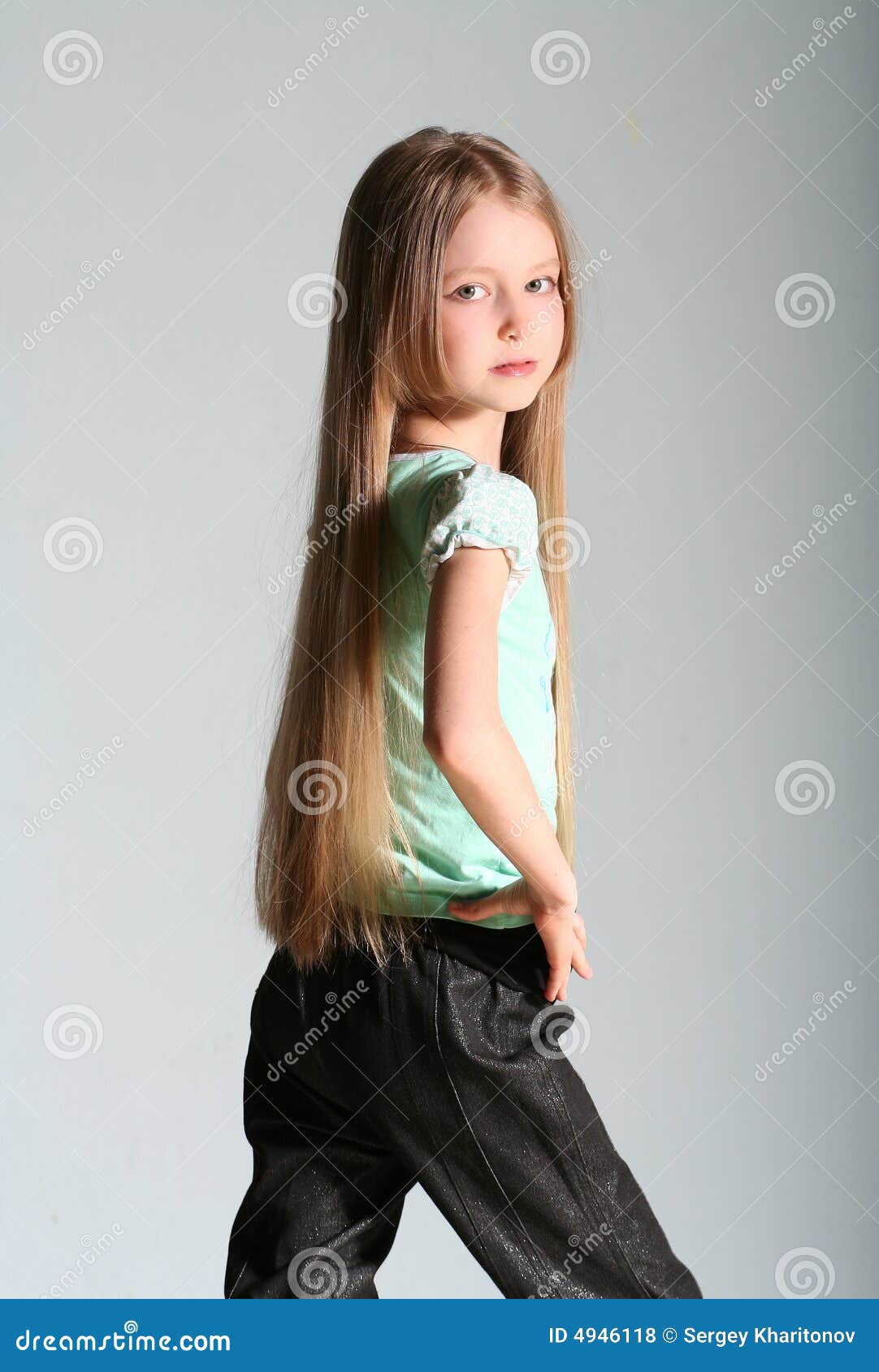 Stylish Model Child Posing Background Brick Wall,loft Interior. Fashion  Girl Kid Hipster In Casual Clothes,pink Jacket, White Sneakers, Jeans.  Lifestyle, Modern Youth Clothing. Stock Photo, Picture and Royalty Free  Image. Image 103469139.