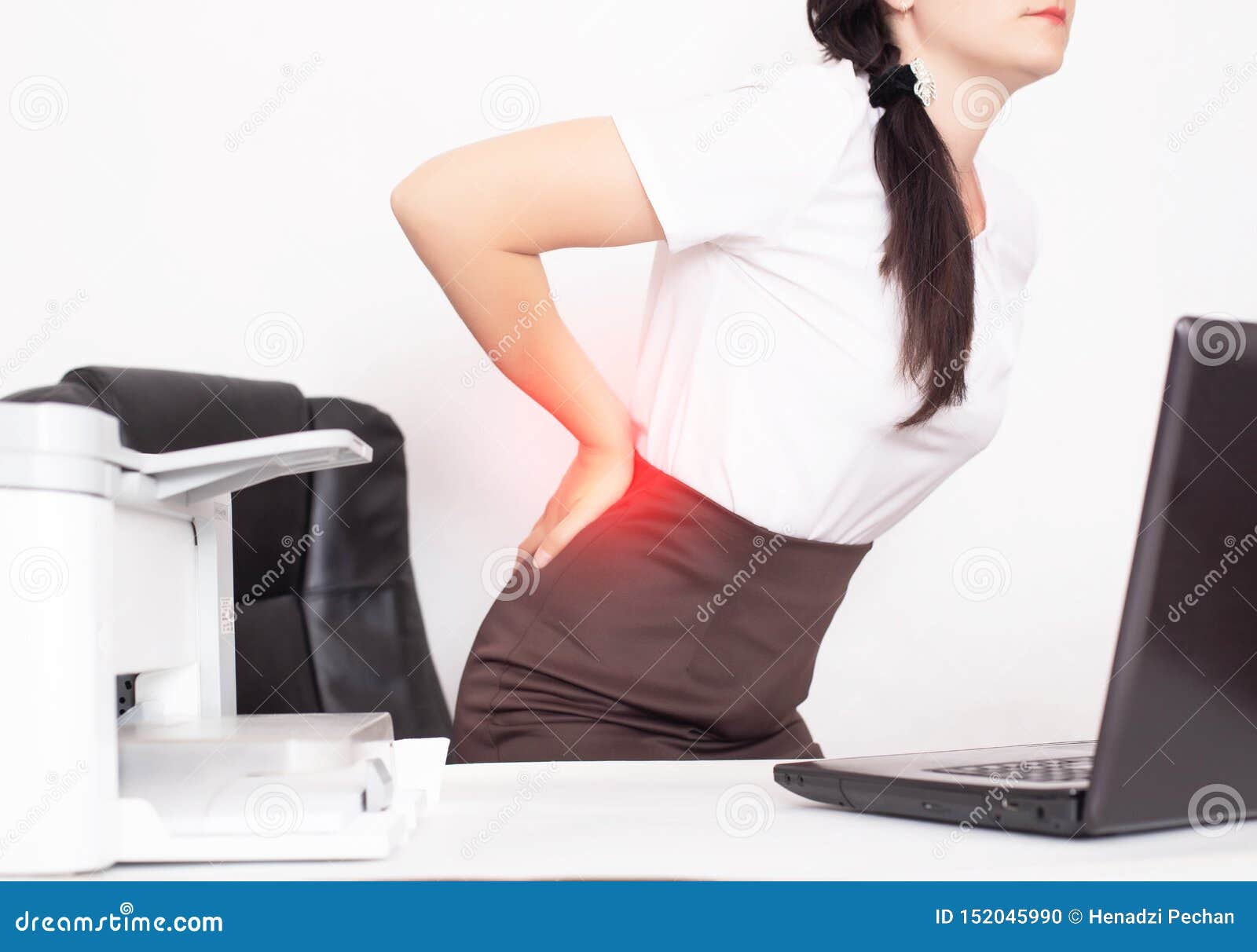 girl office worker holding her aching back from a chair, the concept of back pain in office workers, lactic acid in muscles and