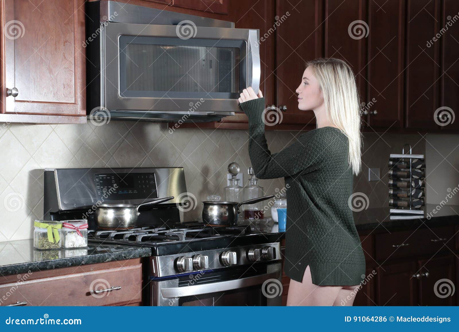 girl opening door of microwave cooker