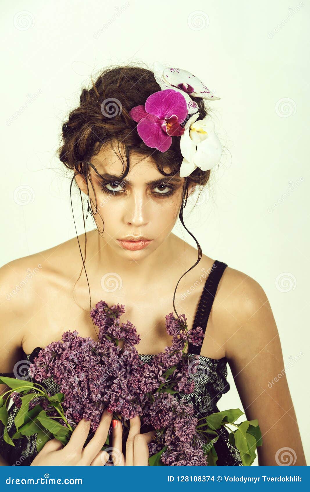 Girl with Orchid Flowers in Hair Holding Lilac Bunch Stock Photo ...