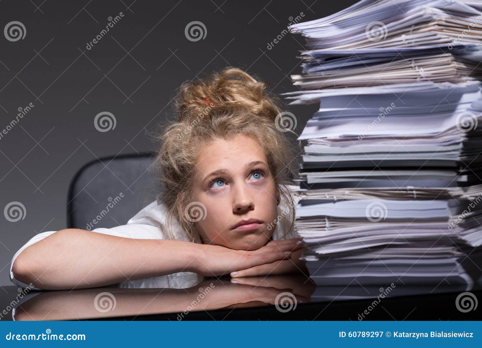 girl overwhelmed by paperwork