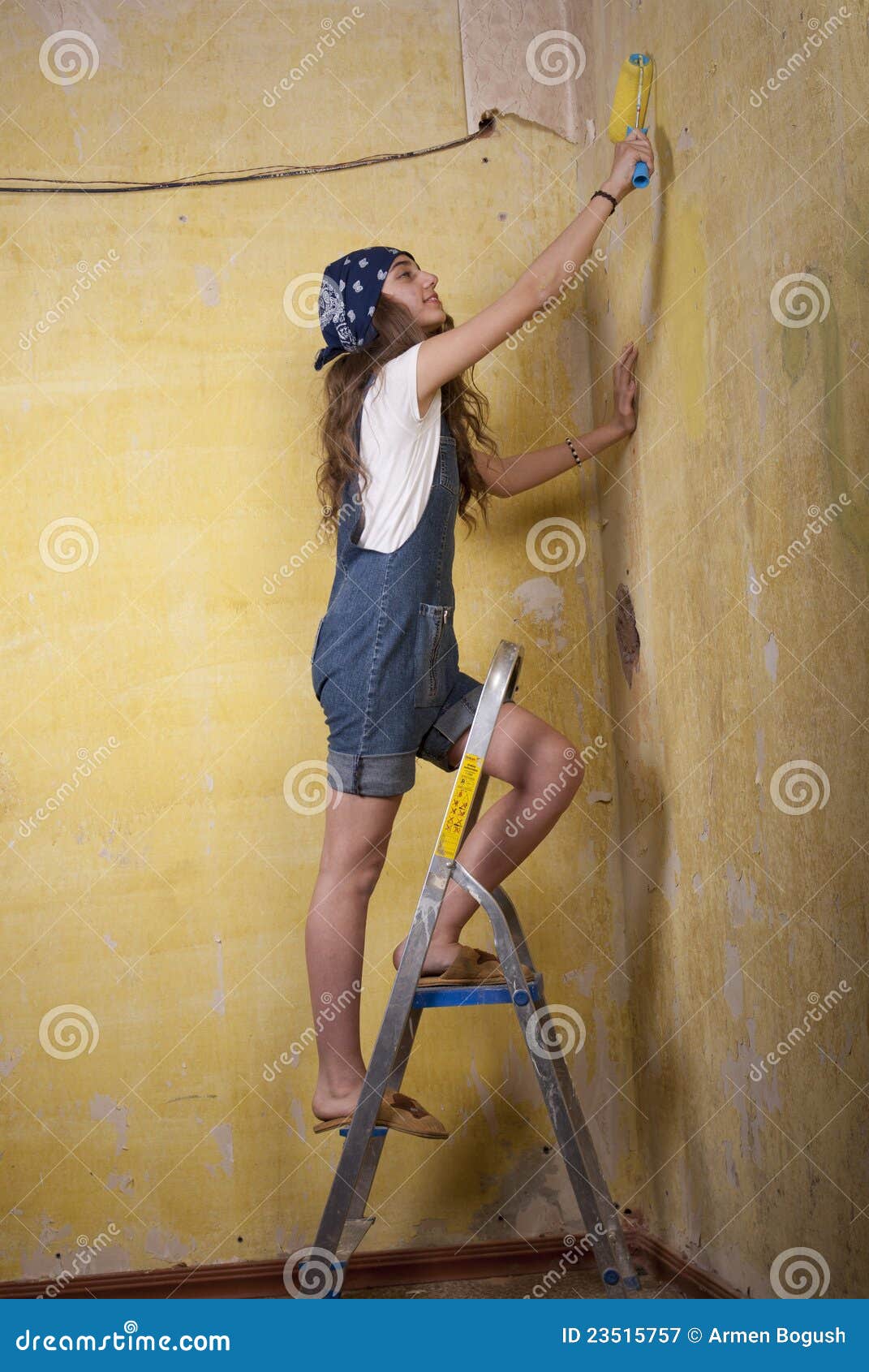 Girl painting on the wall stock image. Image of adorable 23515757