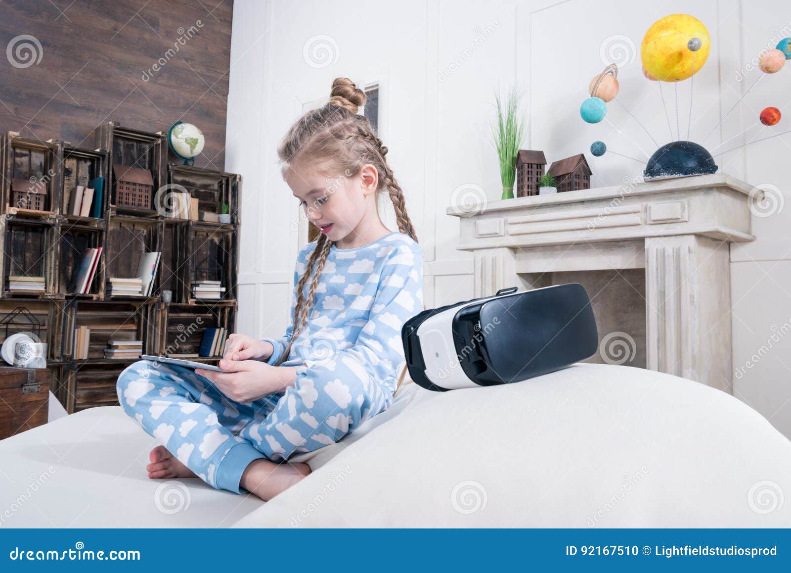 Girl in Pajamas Using Digital Tablet on Bed with Virtual Reality