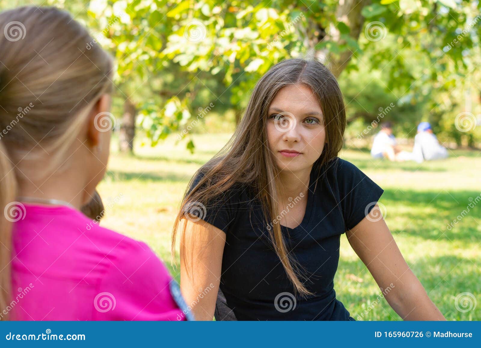 the girl on a picnic listens attentively to the interlocutor