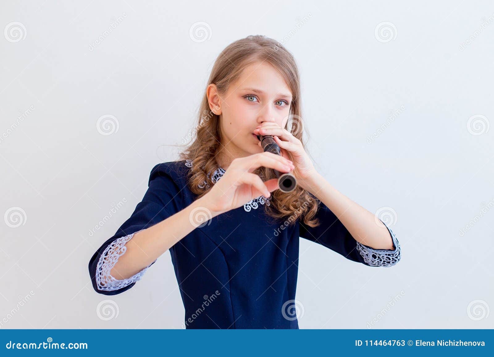 Girl playing on a flute stock image. Image of player 114464763