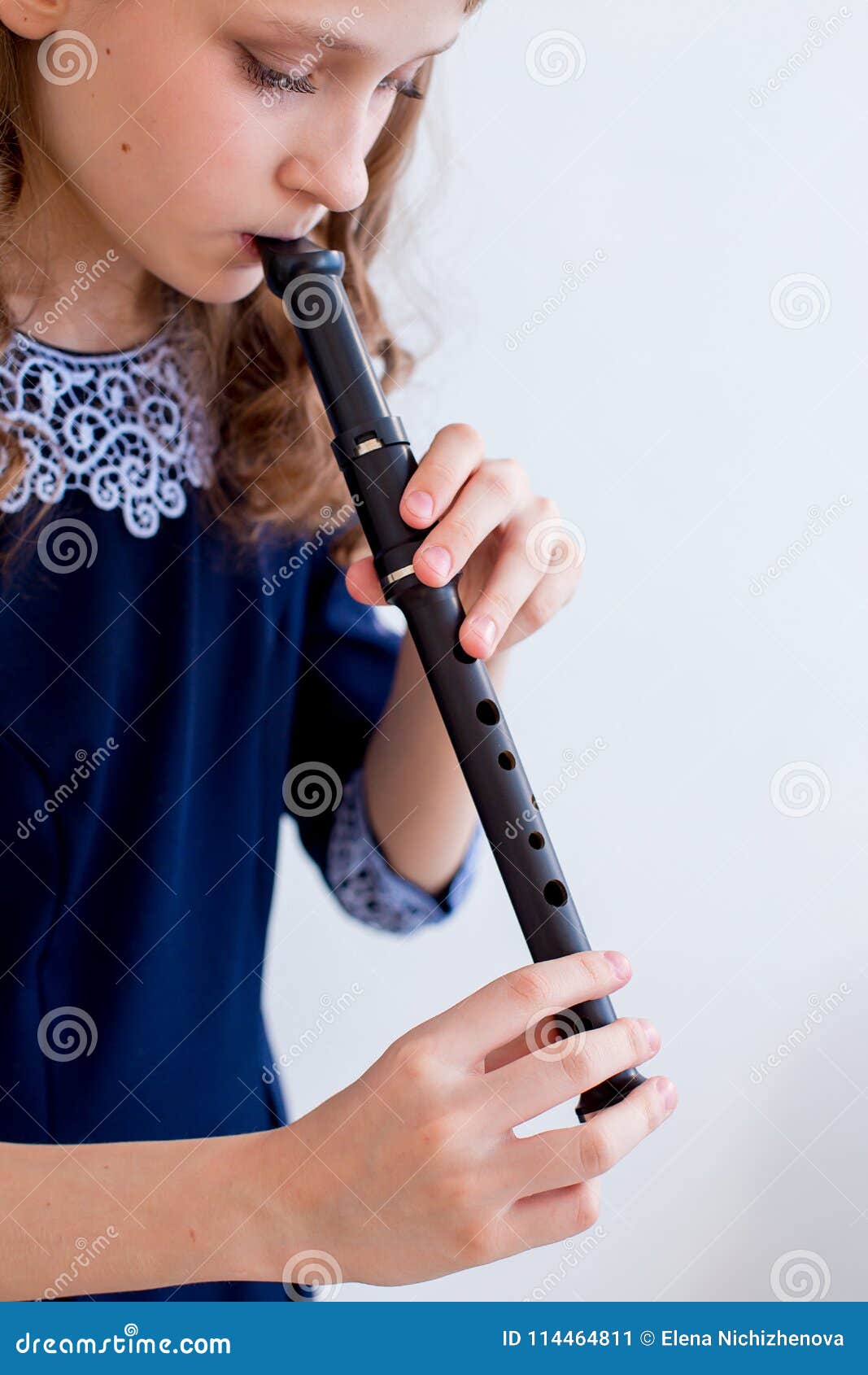 Girl playing on a flute stock image. Image of musical 114464811