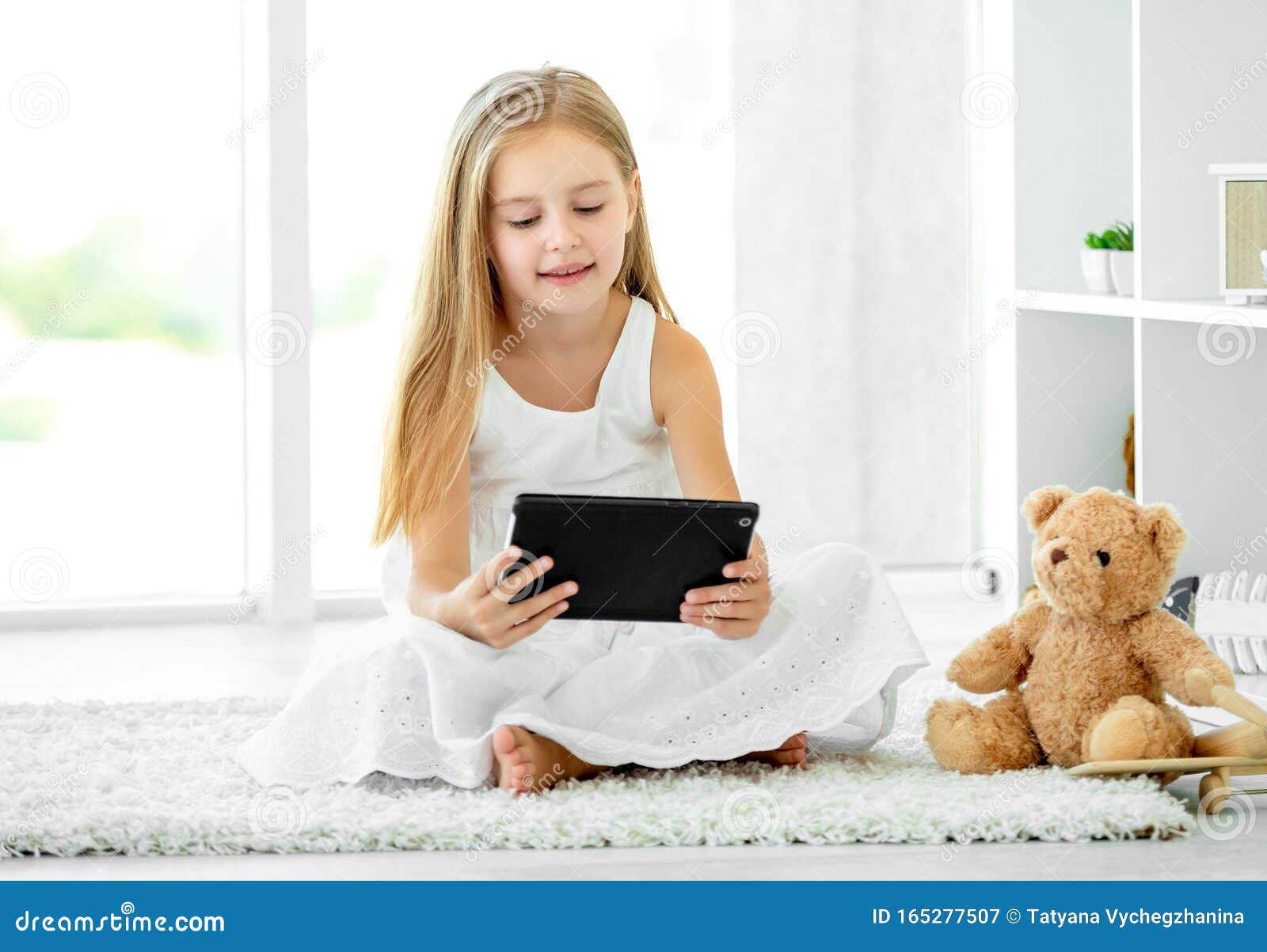 Boy Is Playing In The Tablet On A Bench Royalty-Free Stock Photo ...