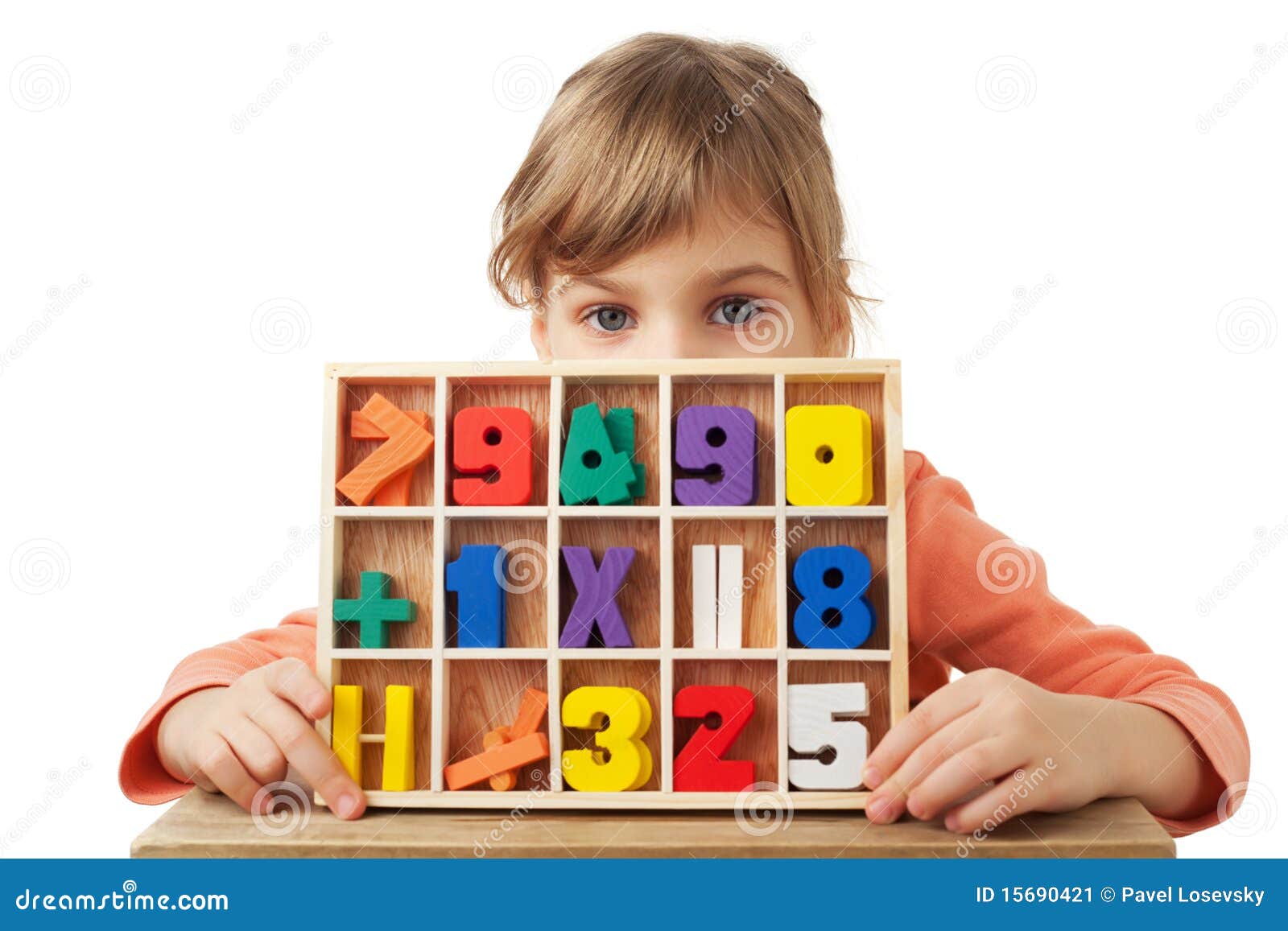 girl plays in wooden figures in form of numerals
