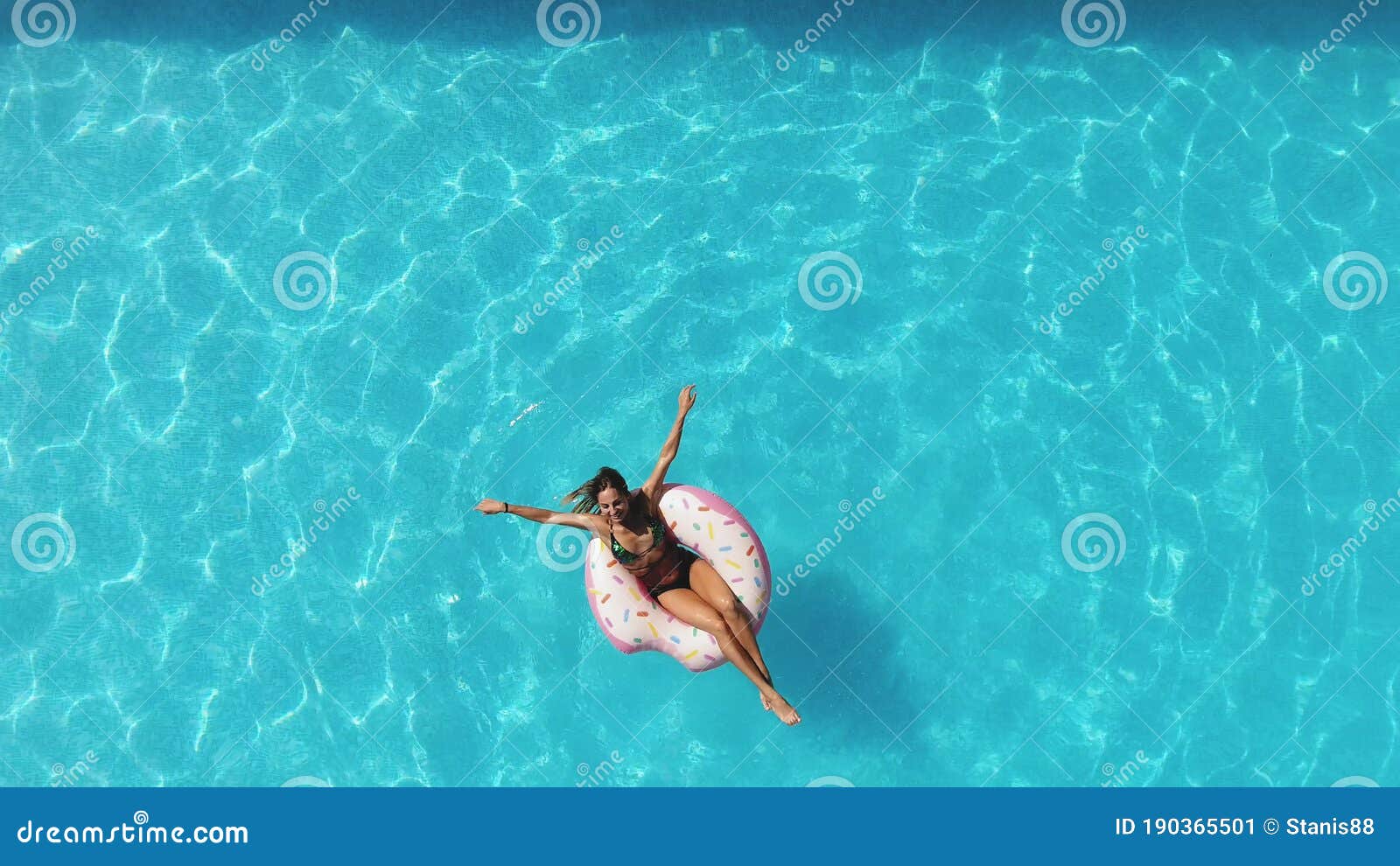 Girl in the Pool Swims on an Inflatable Donut of Pink Color Stock Image ...
