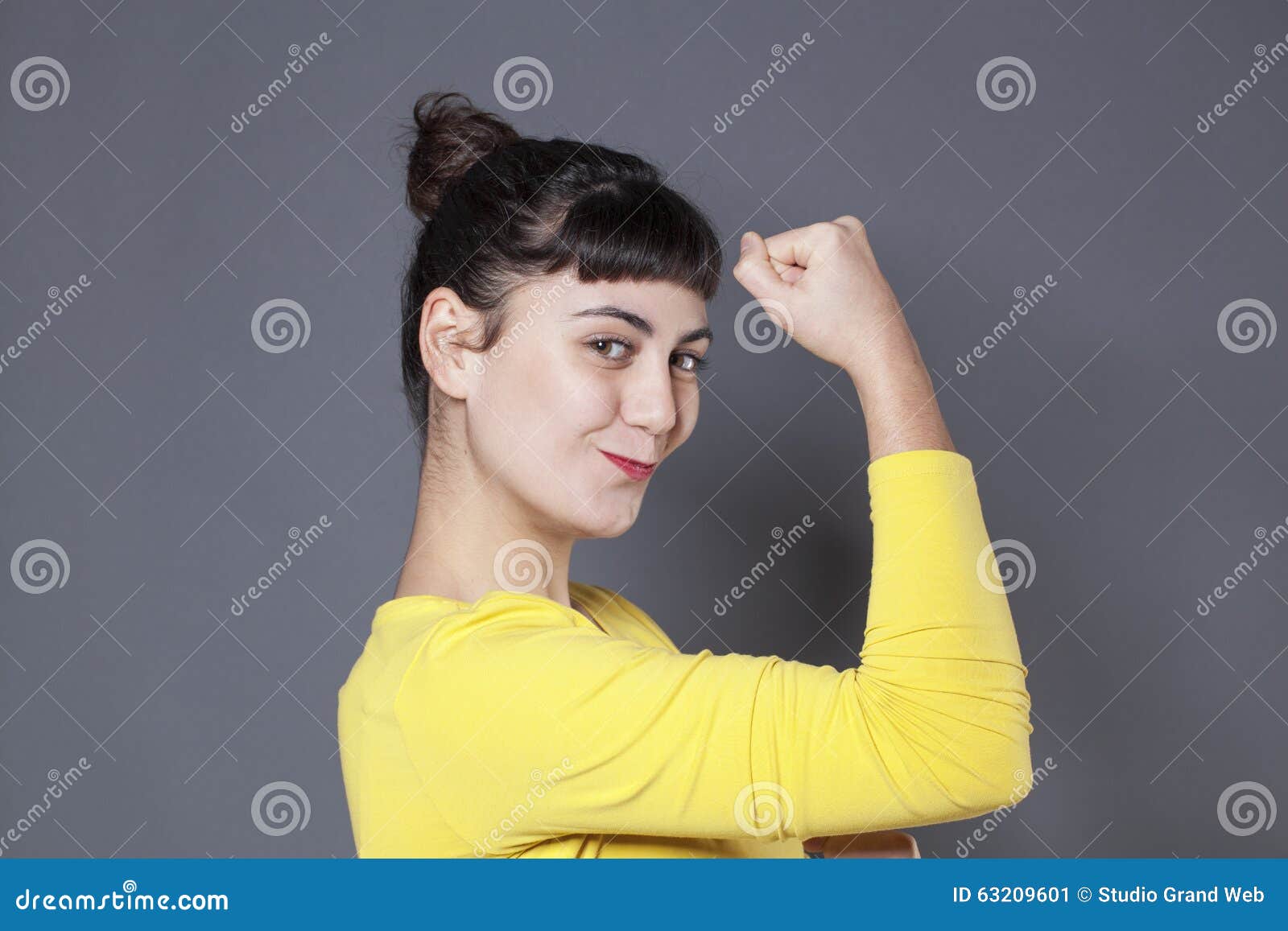 girl power concept for thrilled young brunette