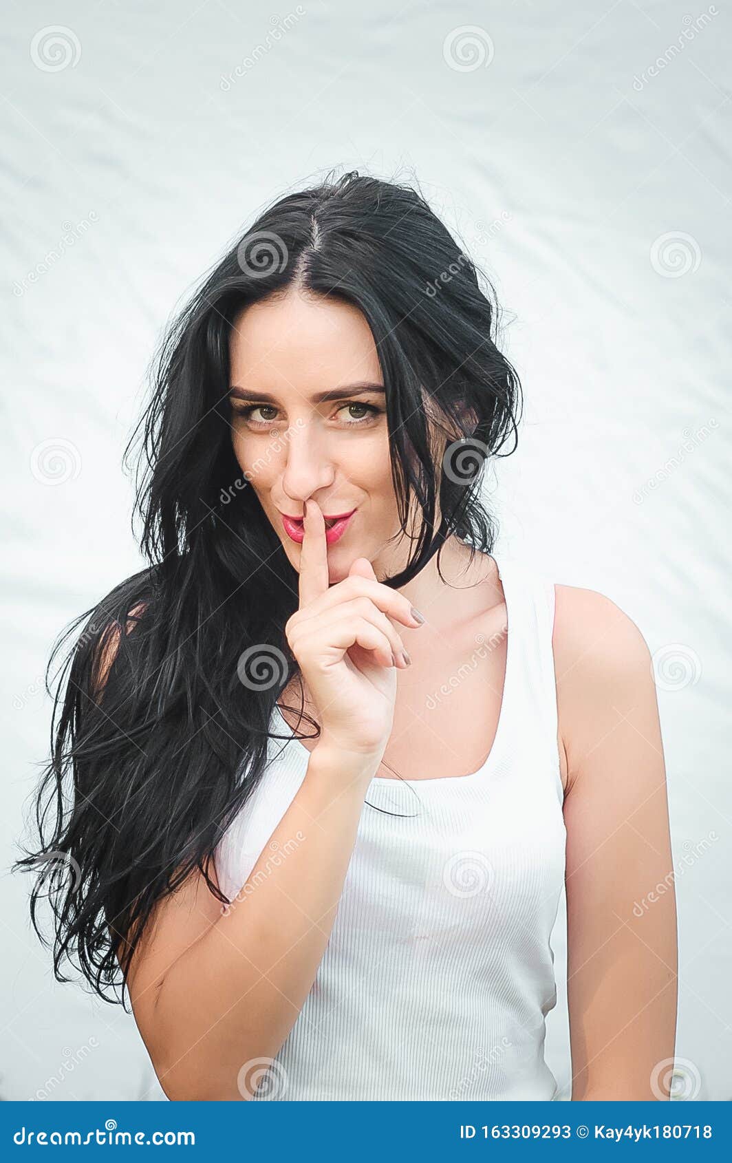 Girl Presses Index Finger To Her Lips Portrait Of A Beautiful Young 