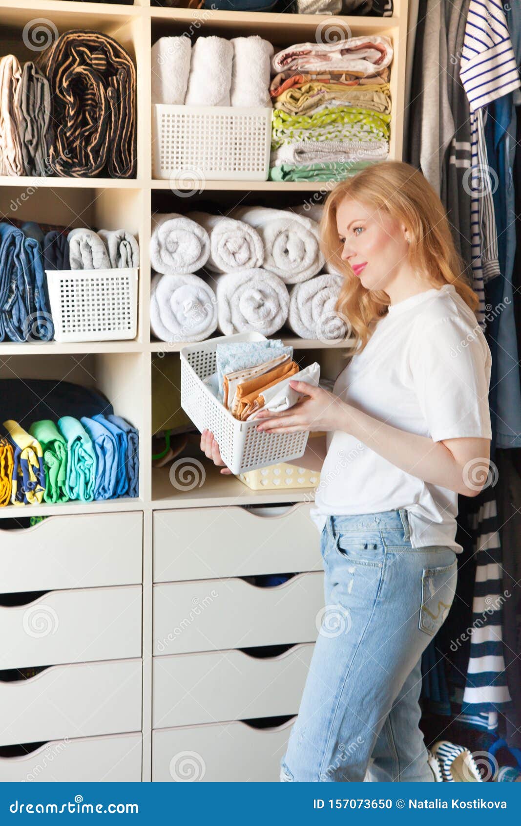 Girl Puts Things in Order in Wardrobe. Vertical Japanese Clothes Storage Stock Photo - Image of shirt, door: 157073650