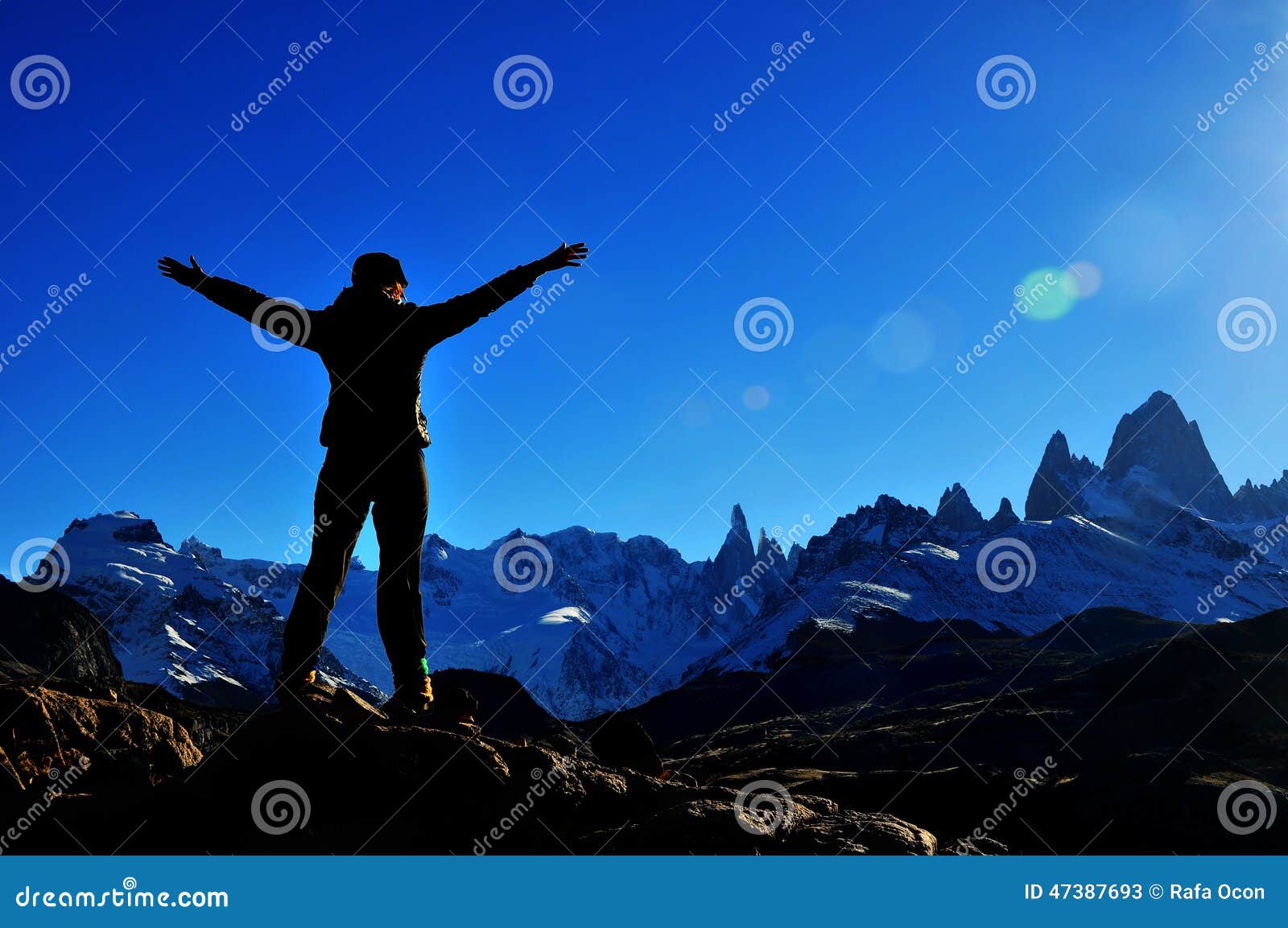 girl reaching the summit of the mountain in el chalten, argentina