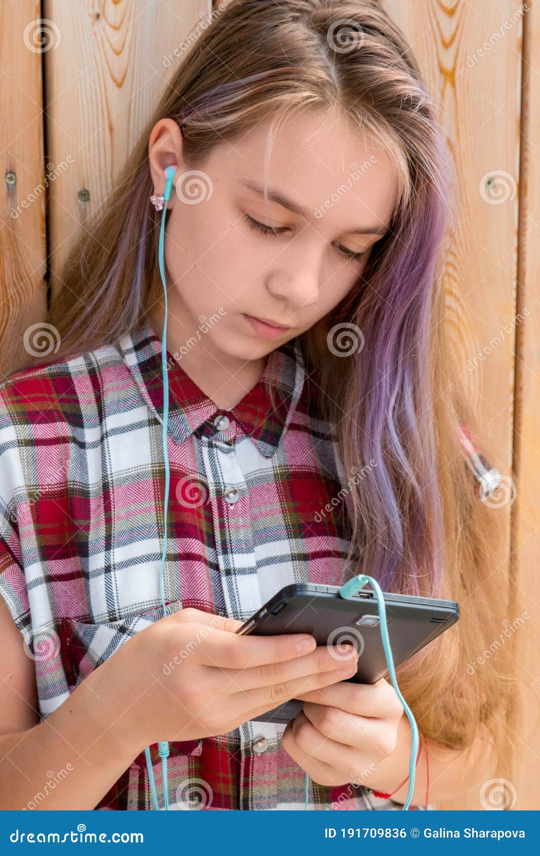 the girl reads a message on a mobile phone. children and gadgets concept.