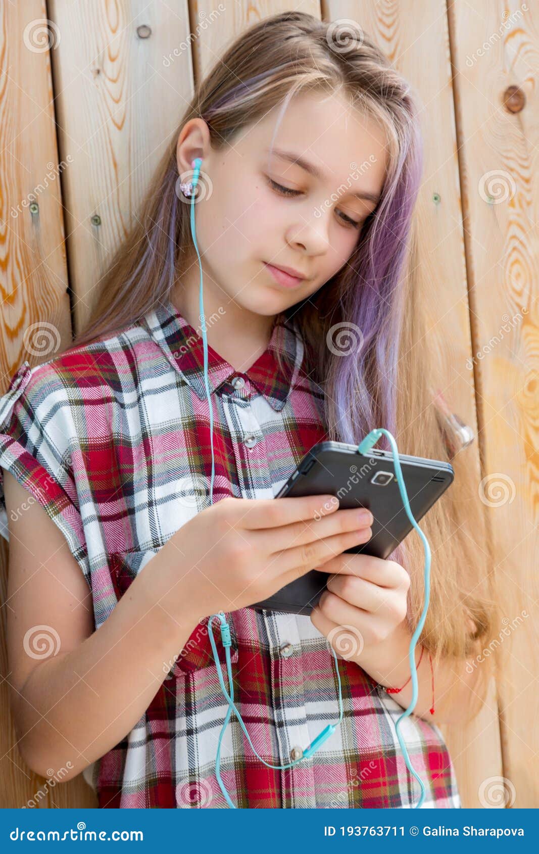 the girl reads a message on a mobile phone. children and gadgets concept.