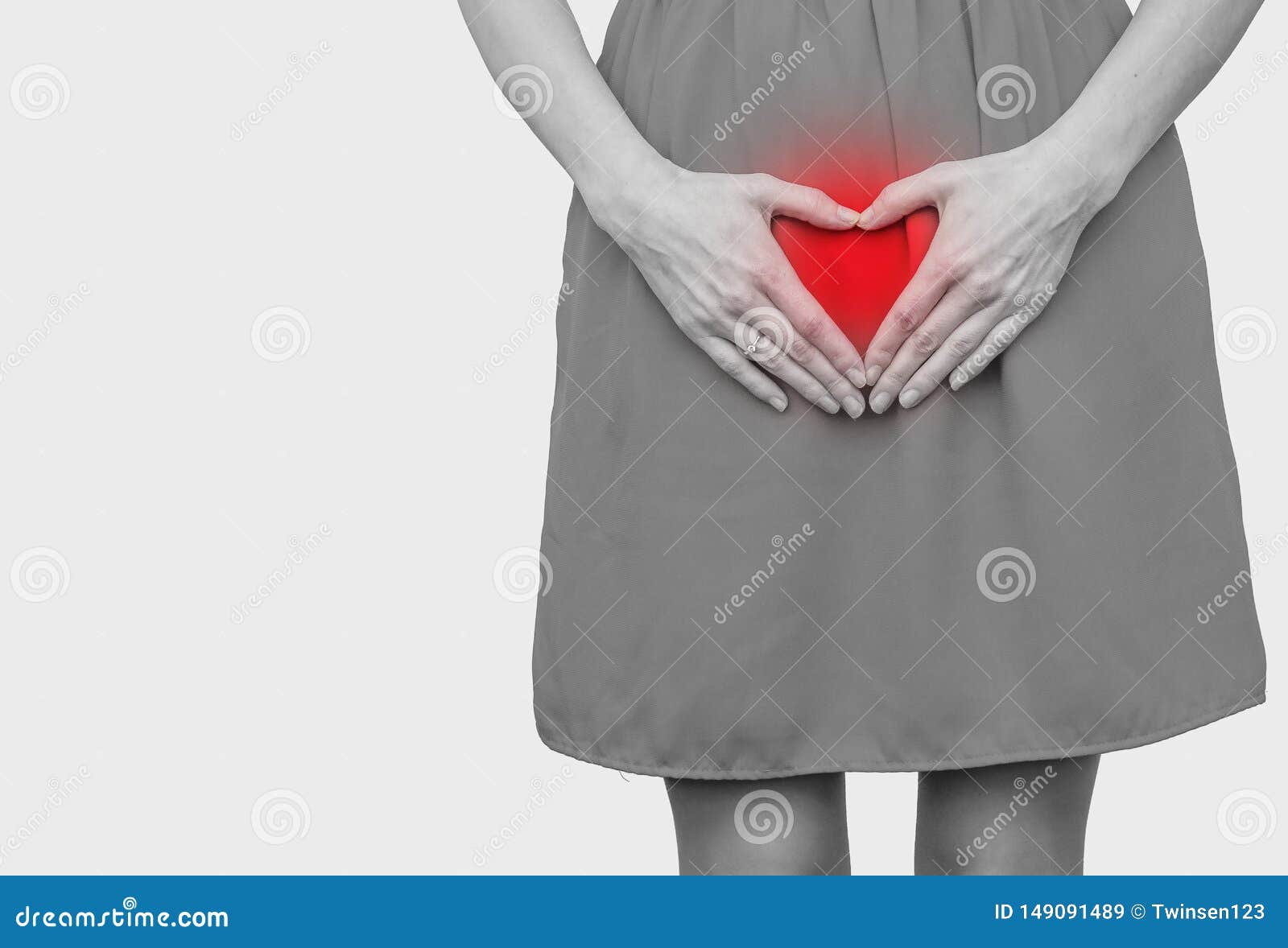 girl in the red dress pressed her hands to the stomach, heart gesture, love. women`s health, sexuality