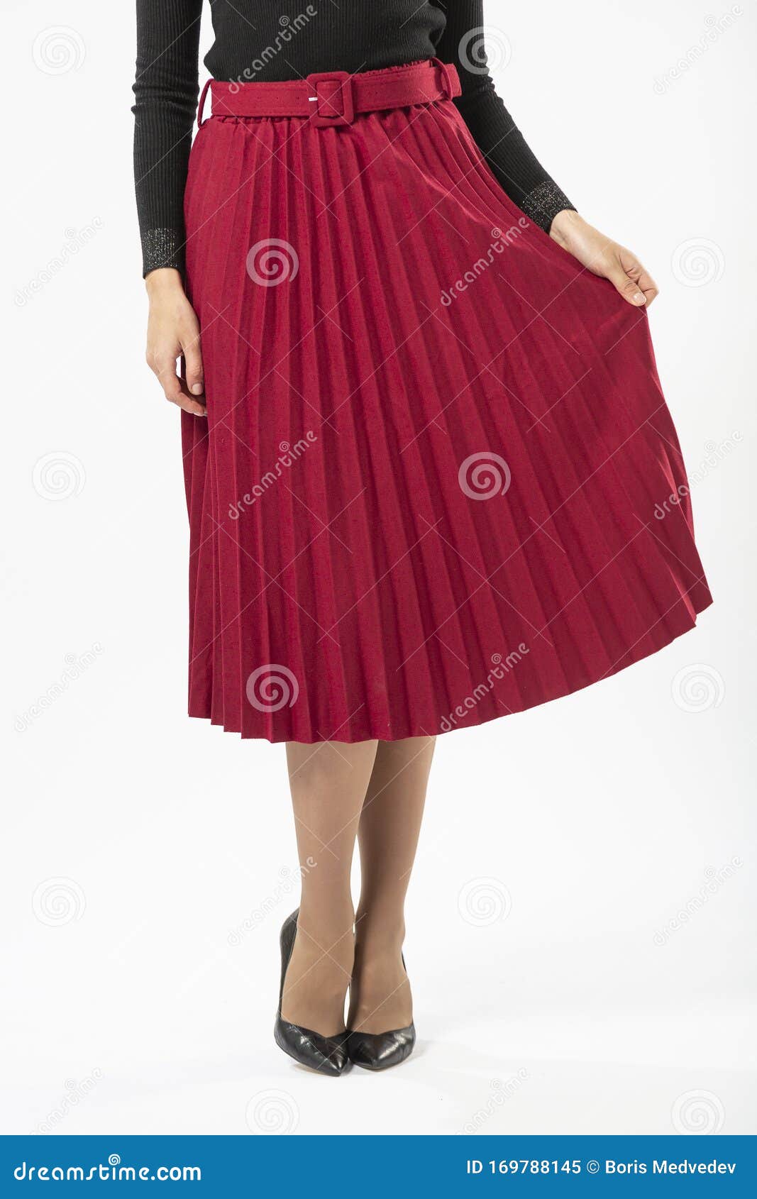 A Girl in a Red Long Ruffled Skirt and Black High Heeled Shoes Stock ...