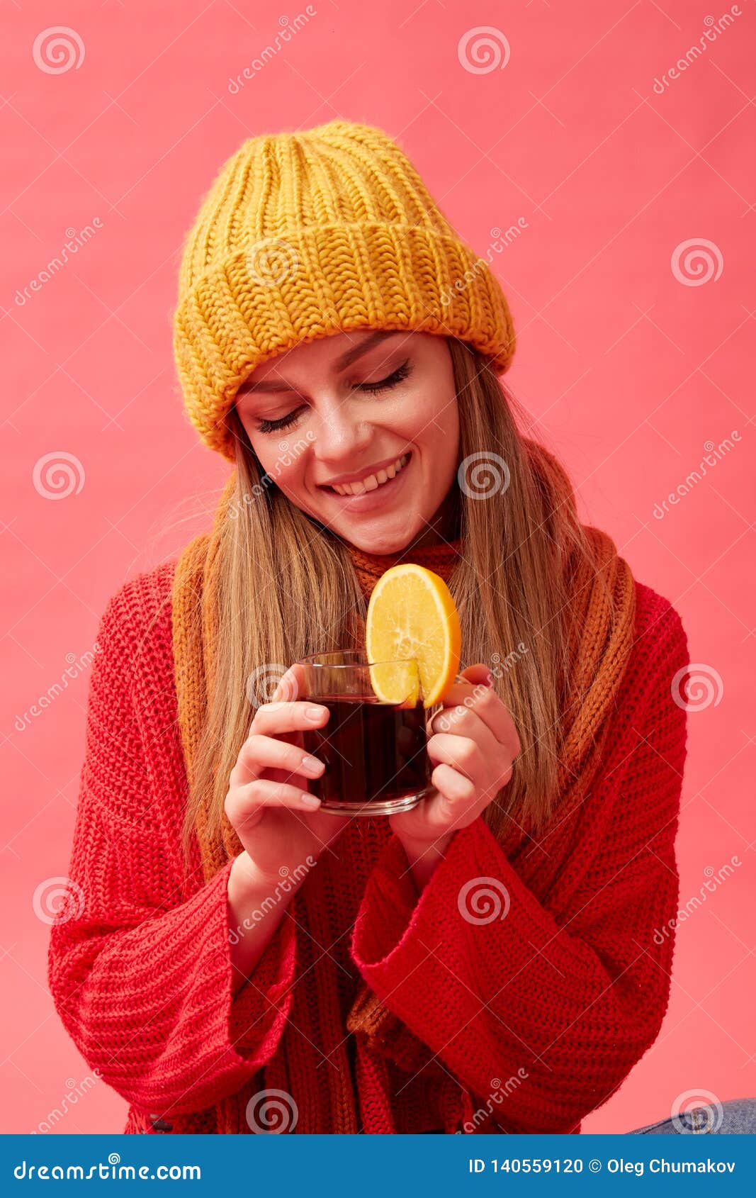 Girl in a Red Sweater and Knitted Hat Holding a Cup of Hot Mulled Wine ...