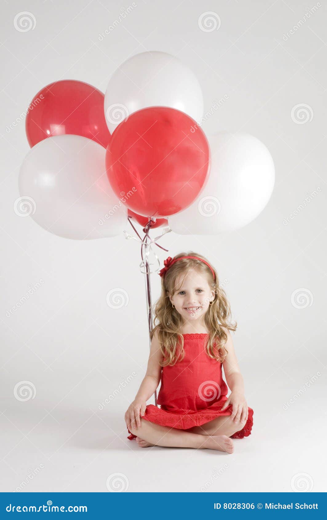 girl with red and white balloons