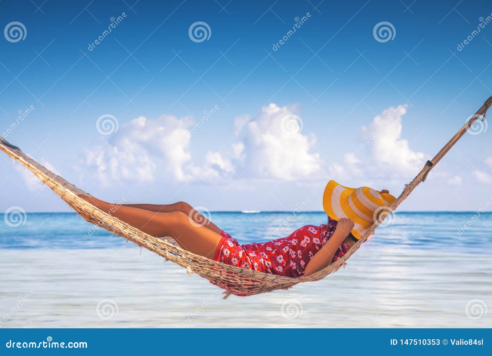 girl relaxing in a hammock on tropical island beach. summer vacation in punta cana, dominican republic