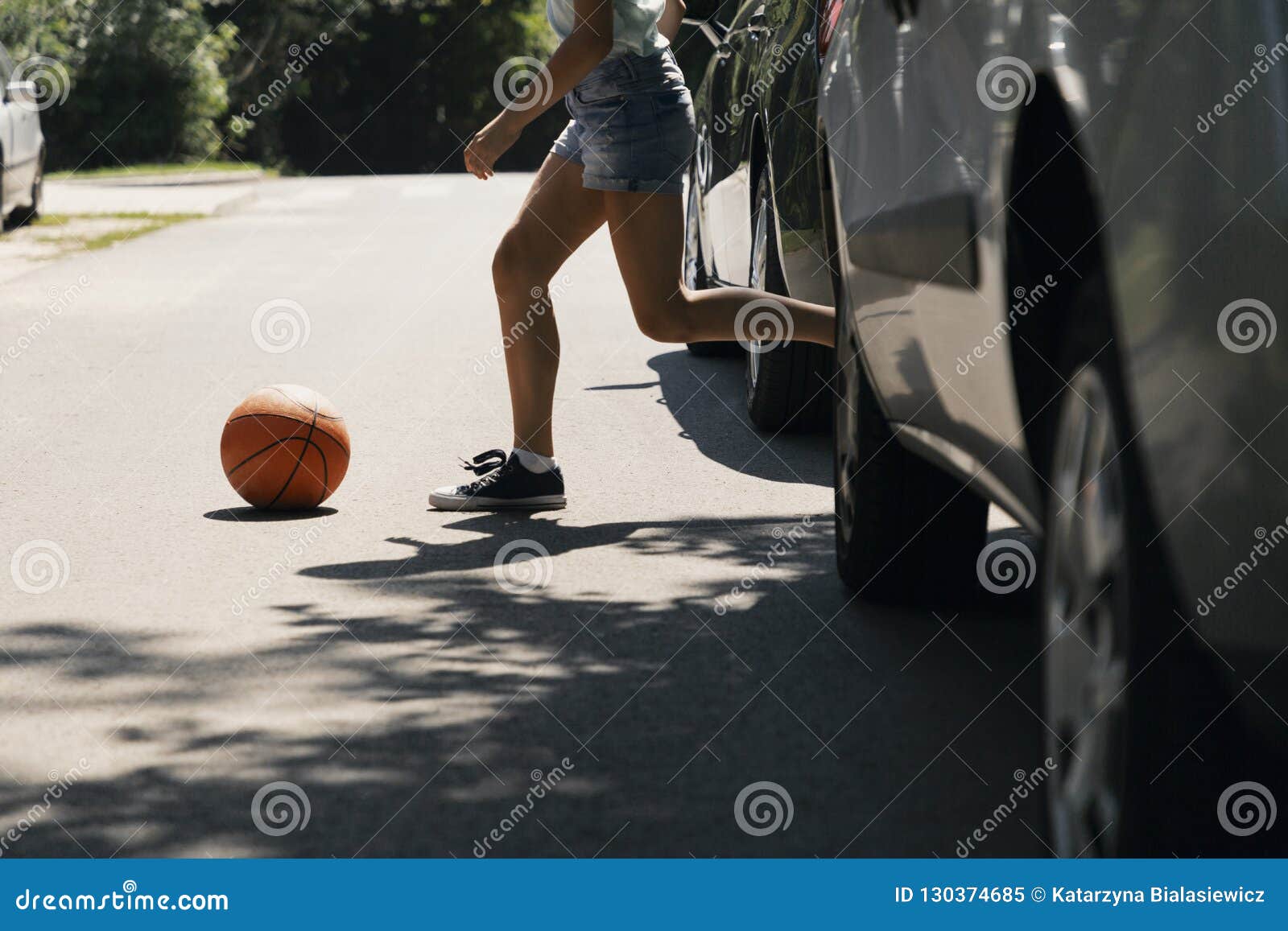 girl running with ball on pedestrian crossing