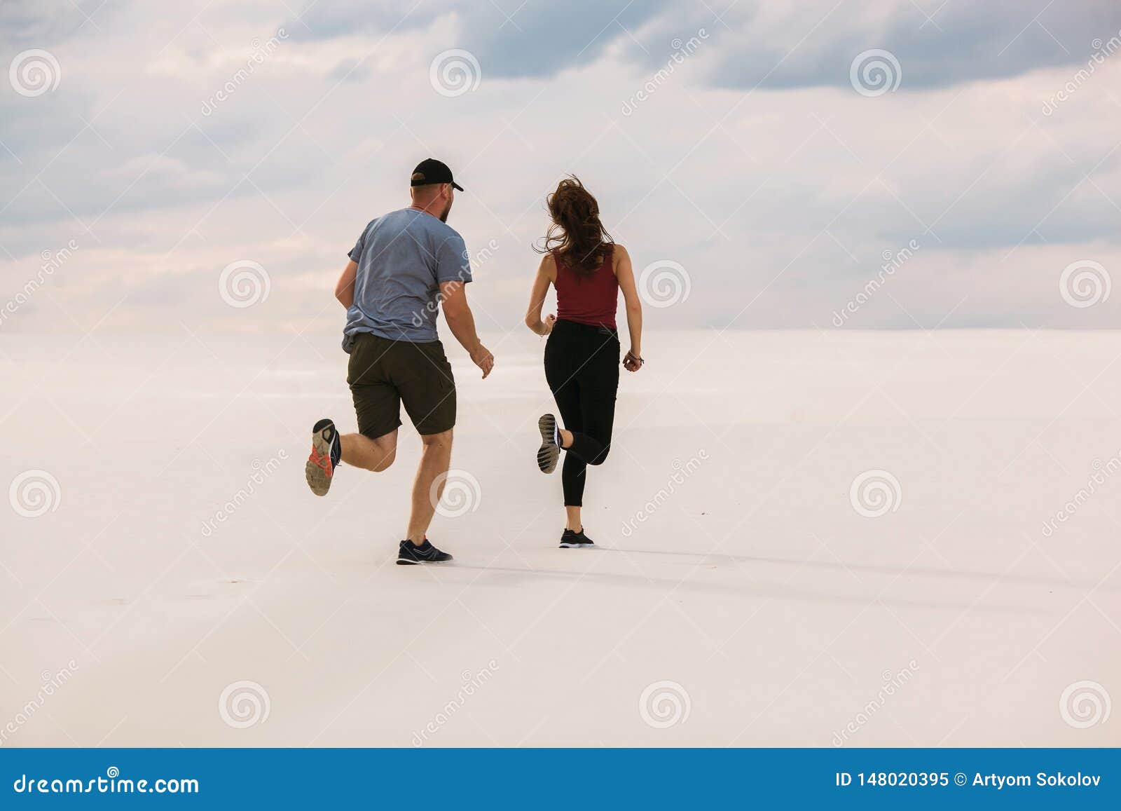 The Girl Runs Away from the Guy in the Desert, the Man Wants To Catch Up  with Her, the Girl is Afraid and Runs Away from Him Stock Image - Image of