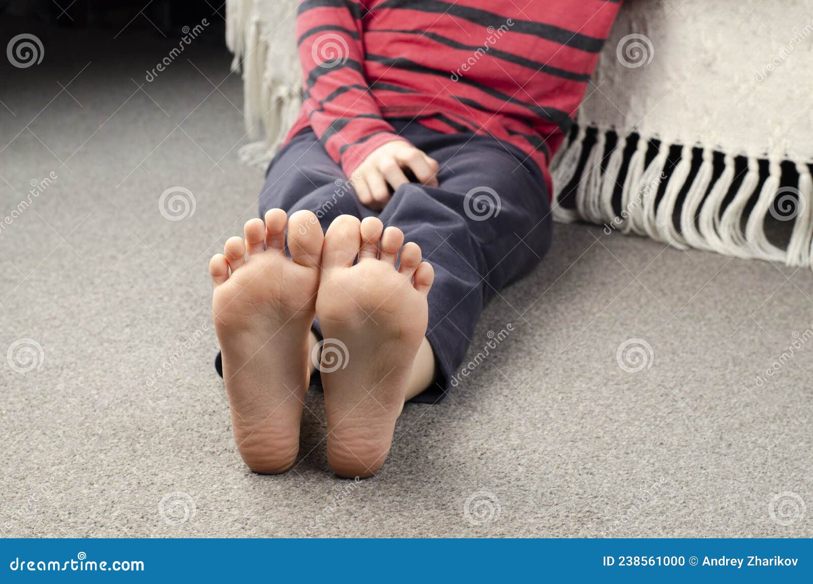 girl`s bare feet. foot heel. girl sitting on the floor. european