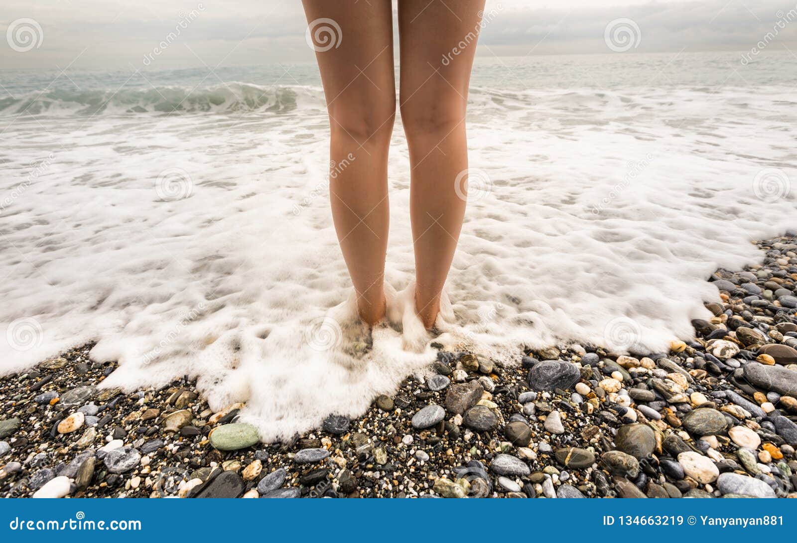girl stepping into the waves girl stepping into the waves
