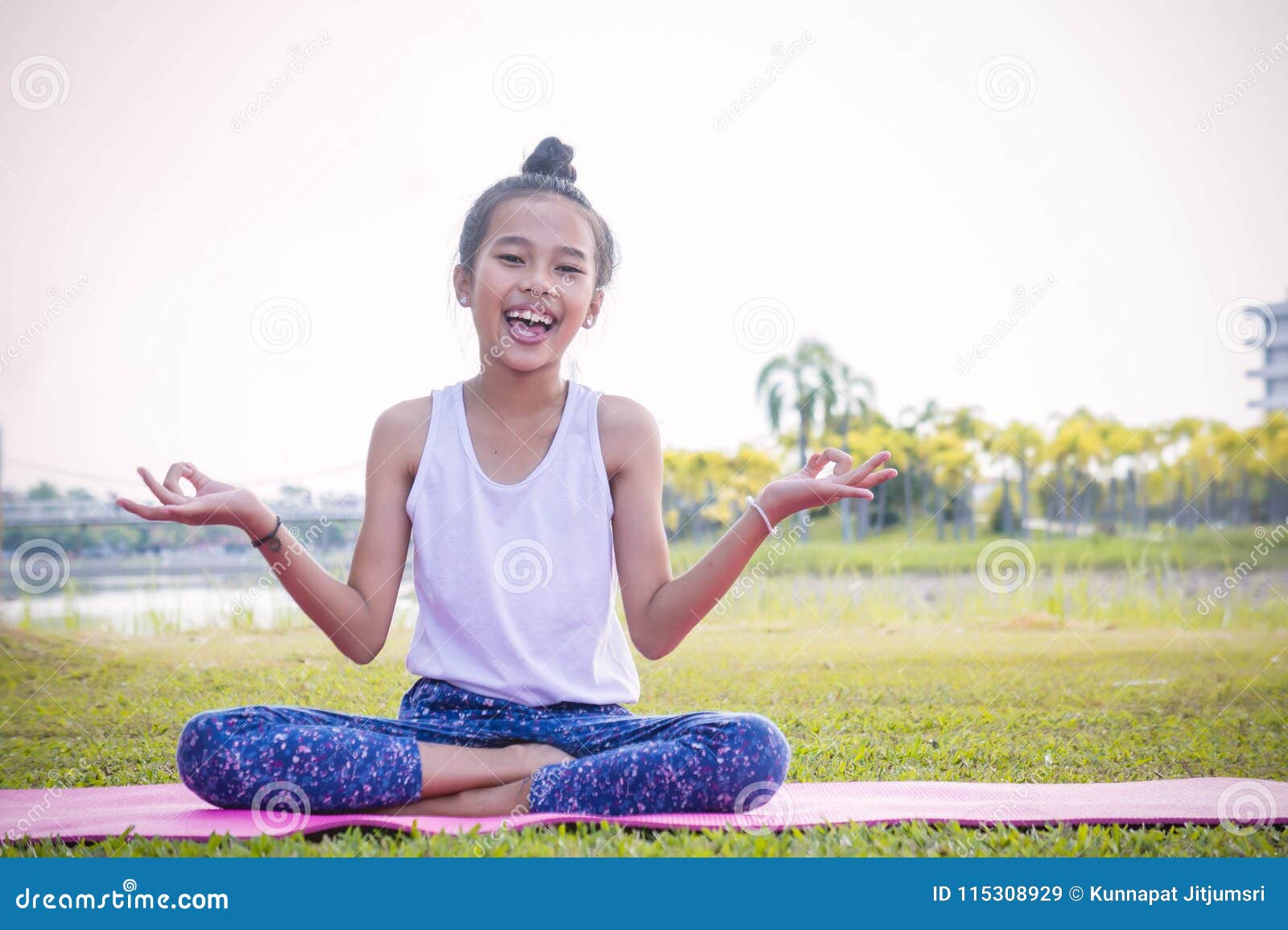 girl`s practicing yoga in the park strengthens concentration an