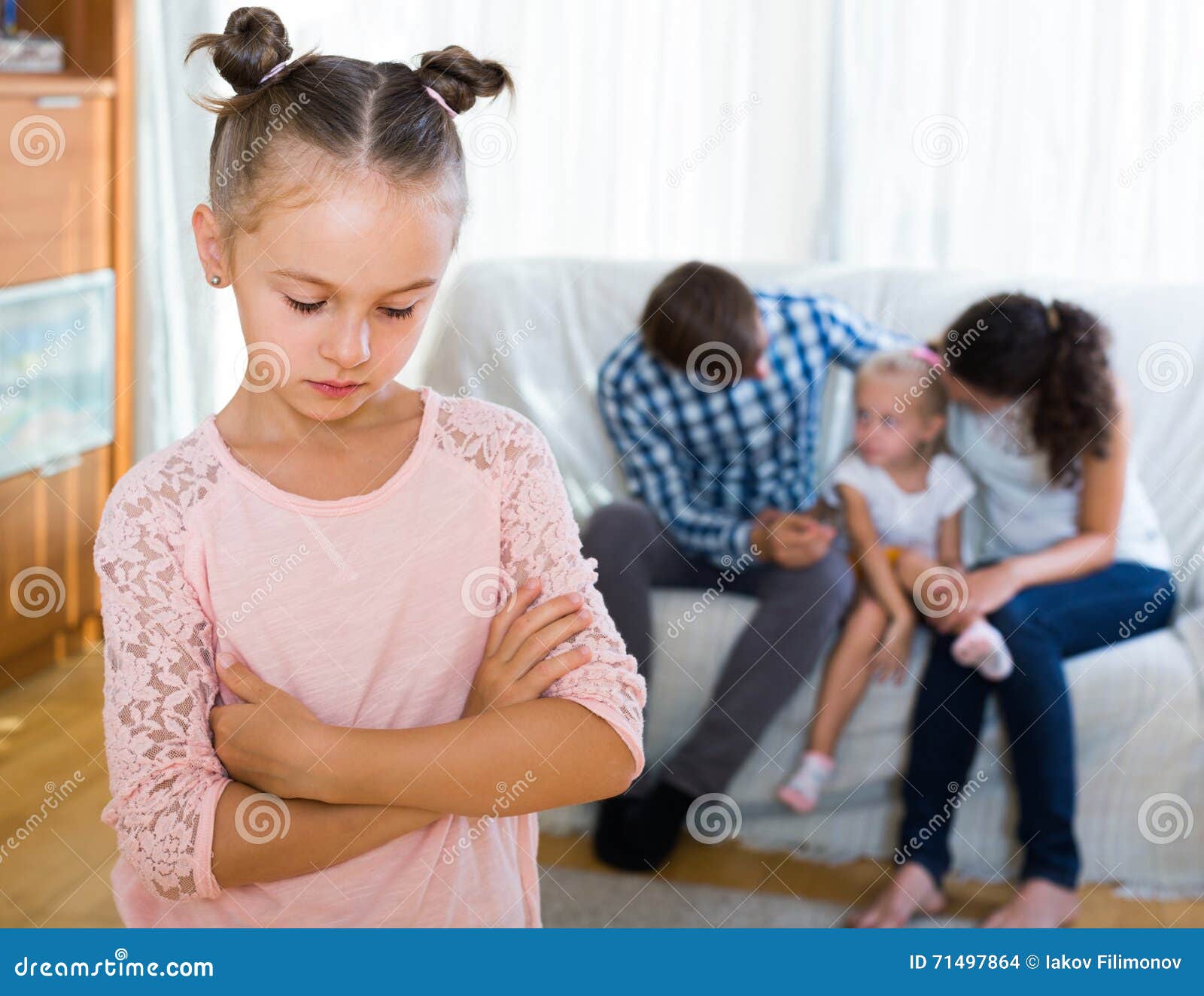 girl sad because of jealous younger sister to parents