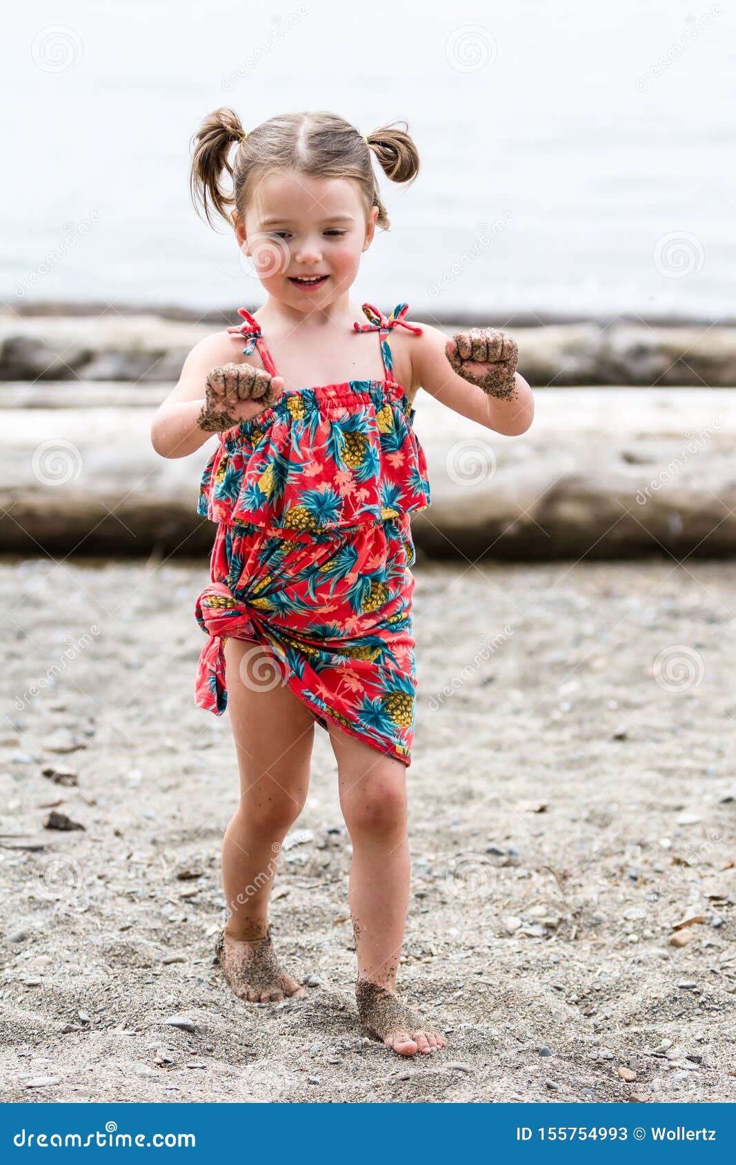 girl with sand on her hands
