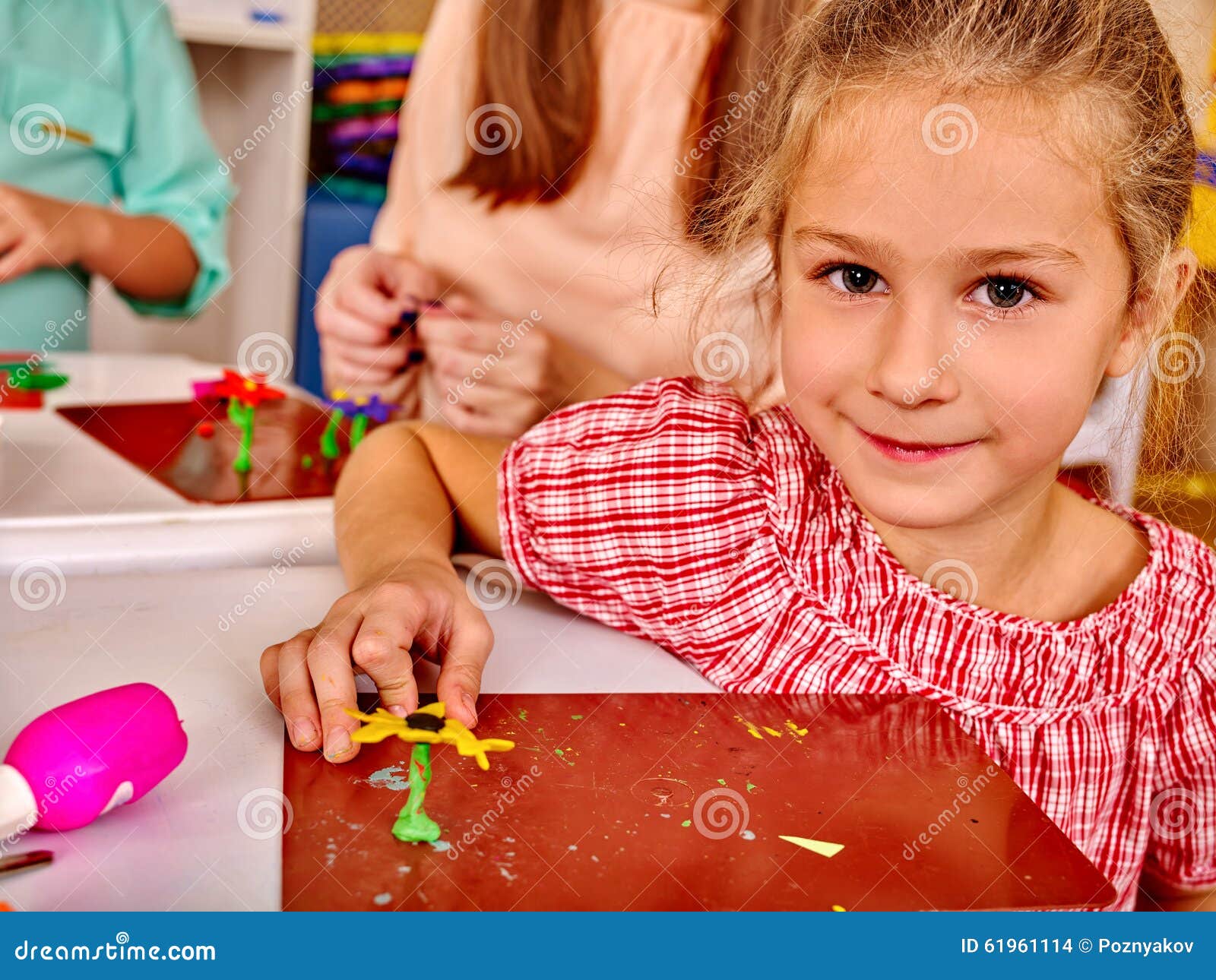 girl sculpt of plasticine on desk in