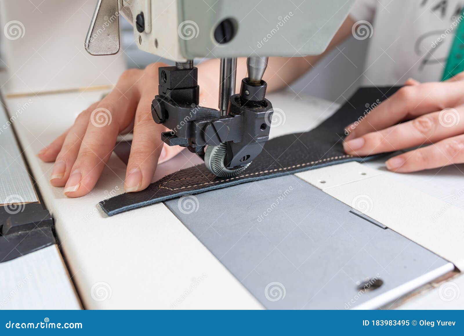 Girl Sews on a Sewing Machine Scribbles Fabric and Leather Making a