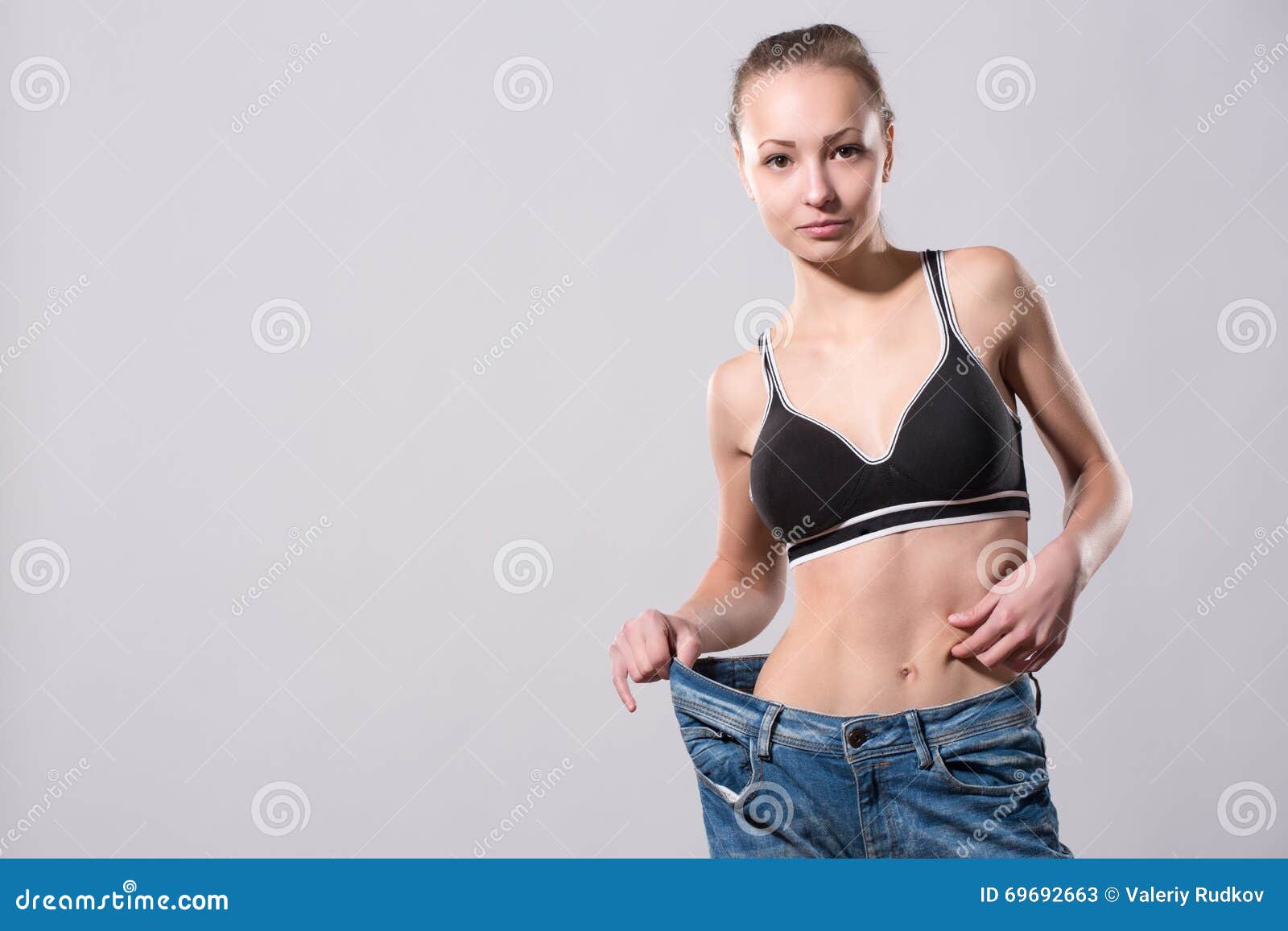 Girl Shows Her Weight Loss By Wearing An Old Jeans Stock Image Image