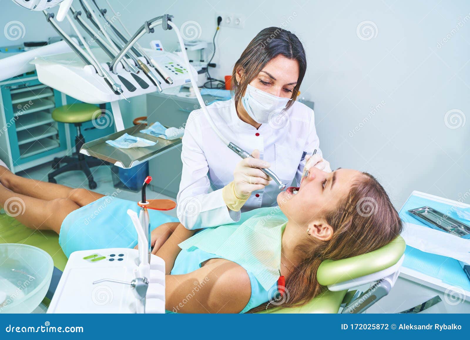 Girl Sitting at Dental Chair with Open Mouth during Oral Check Up while  Doctor. Visiting Dentist Office Stock Photo - Image of open, healthy:  172025872