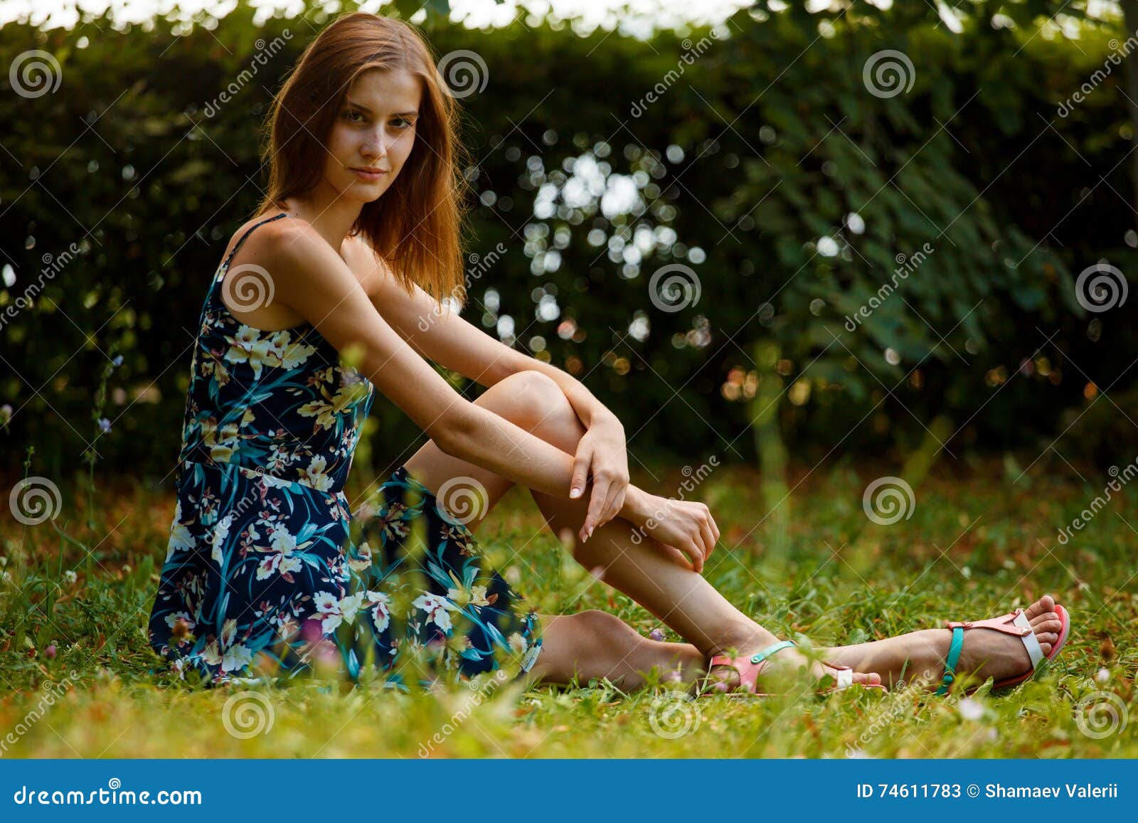 Girl Sitting in the Park with the Edge of the Road on the CurbSlender ...