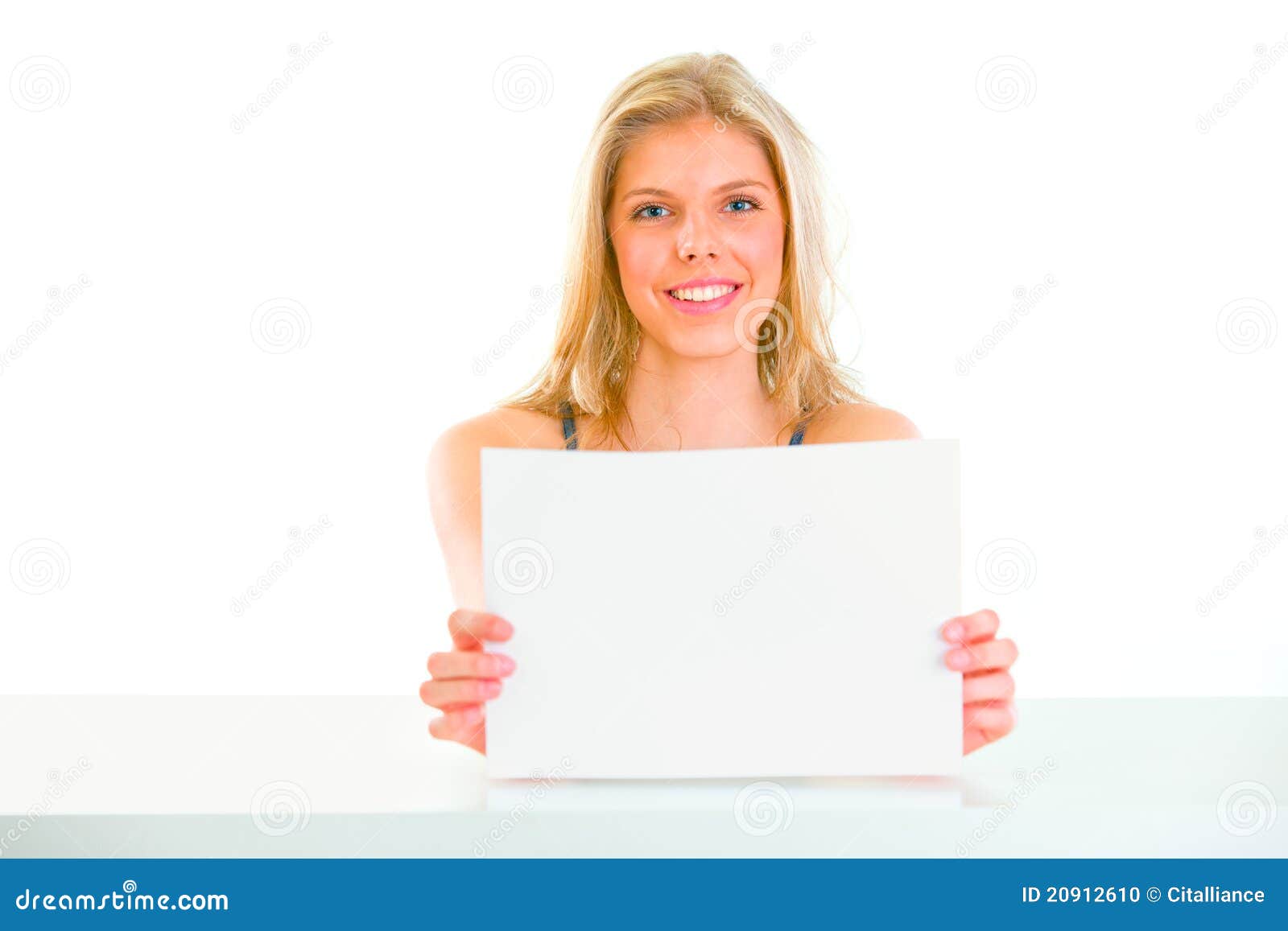 girl sitting table holding blank paper 20912610