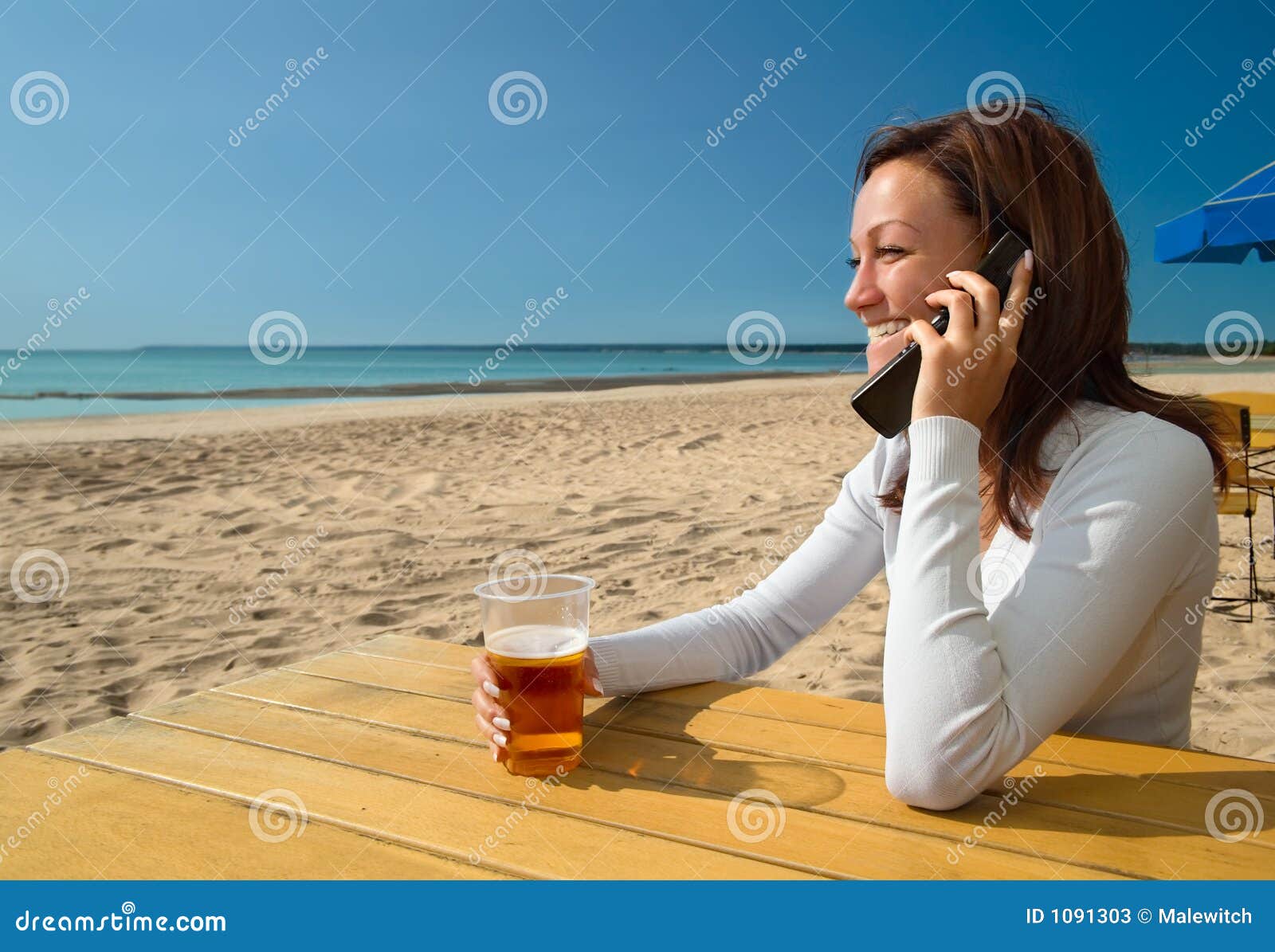 Girl Sitting&talking by Phone on a Beach Stock Image - Image of drink ...
