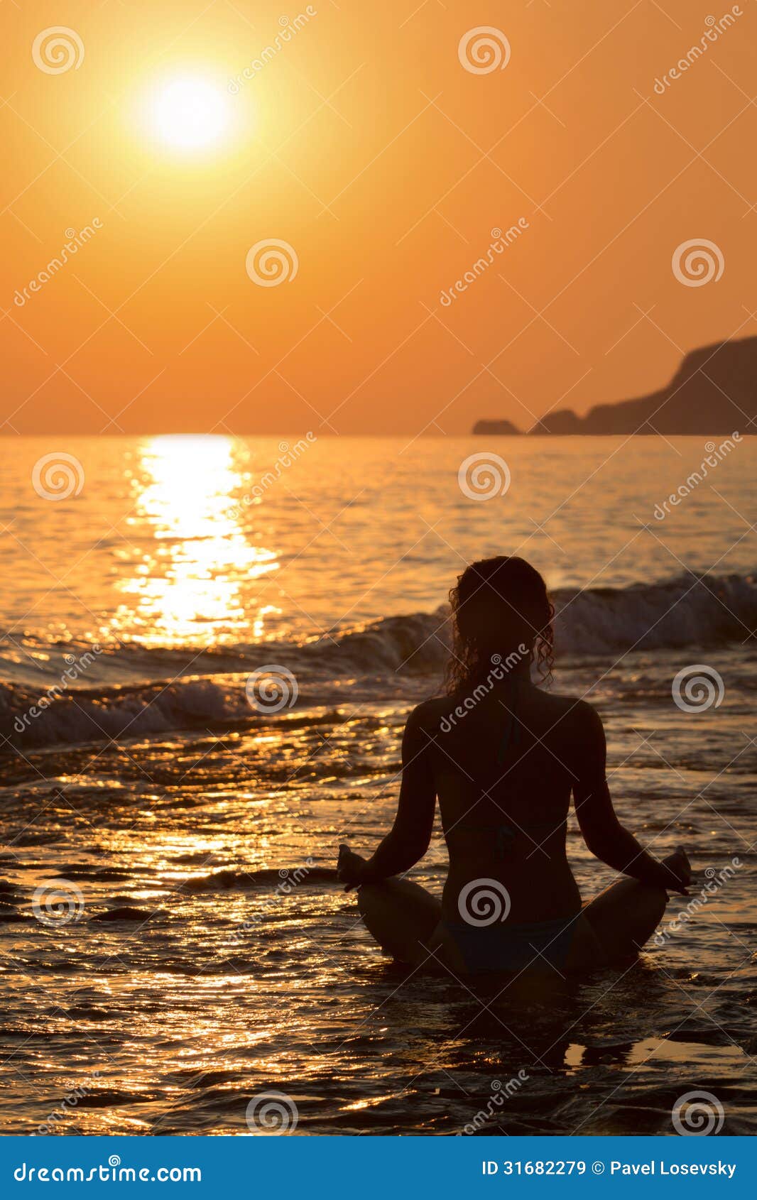 Yoga Pose At The Beach During Sunset Stock Photo