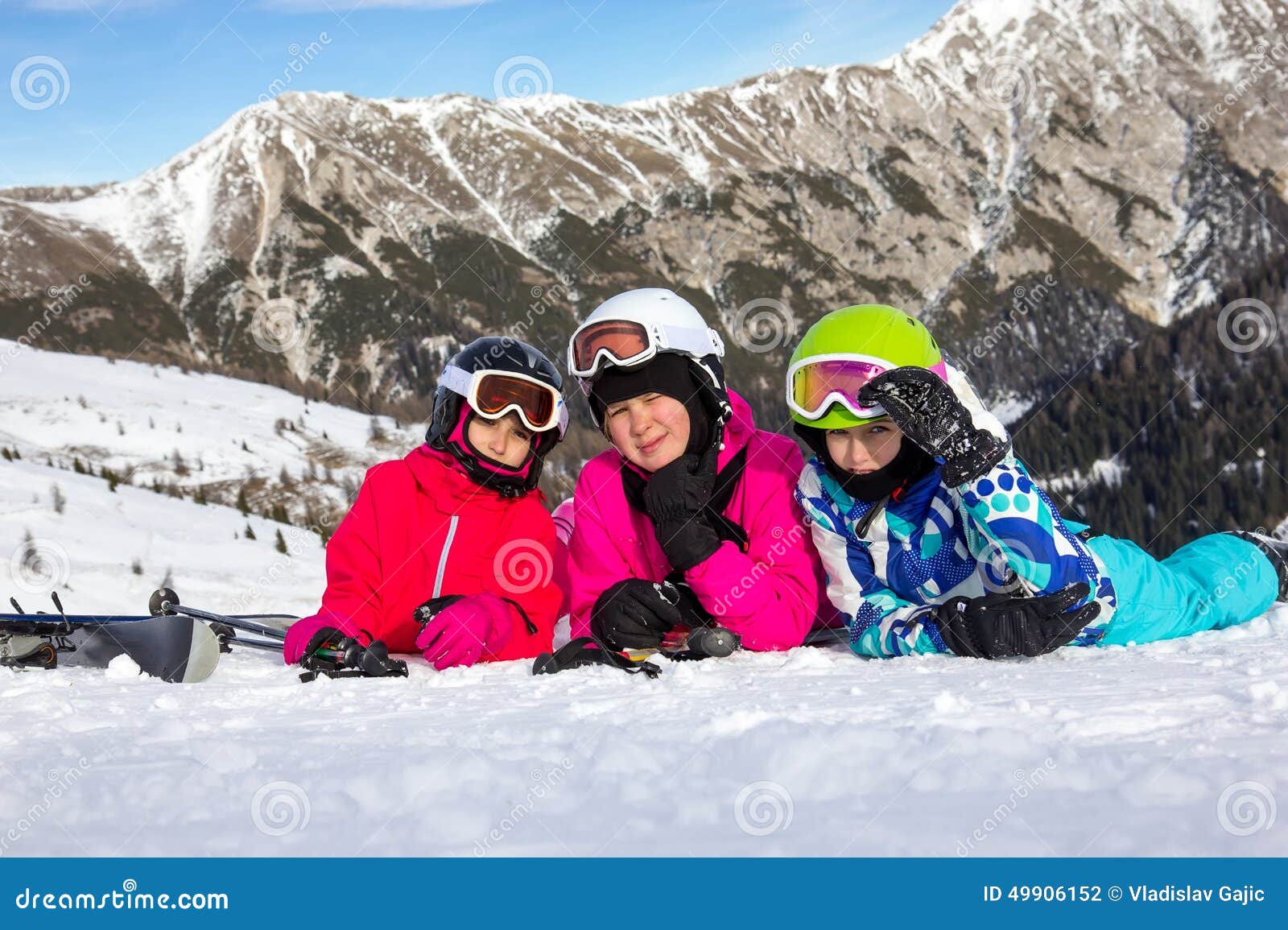 Girl with Ski Lying on the Snow Stock Photo Image of group, child