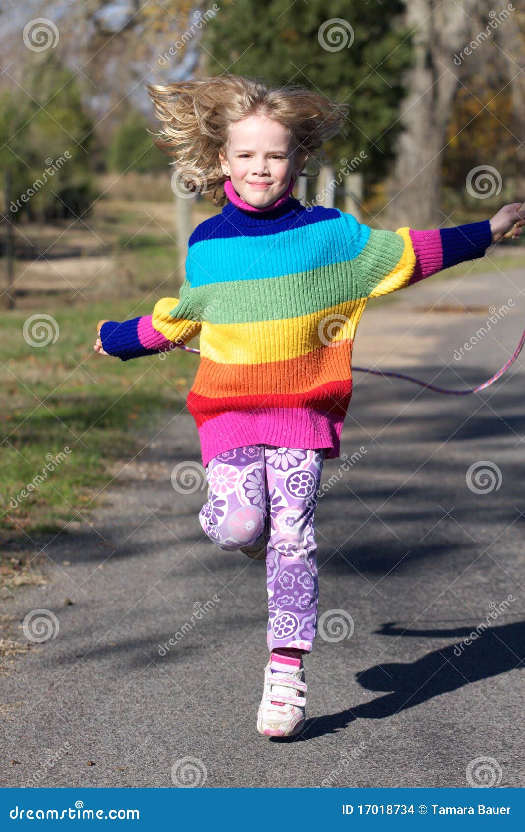 Girl skipping stock photo. Image of green, active, blue 17018734