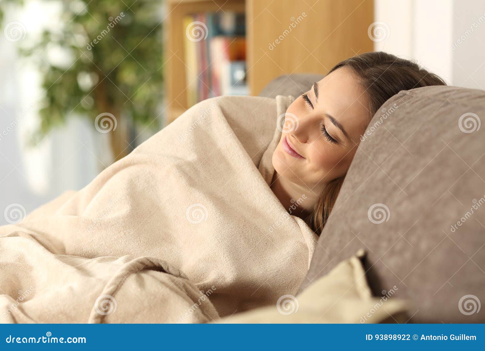 girl sleeping warmly on a comfortable couch