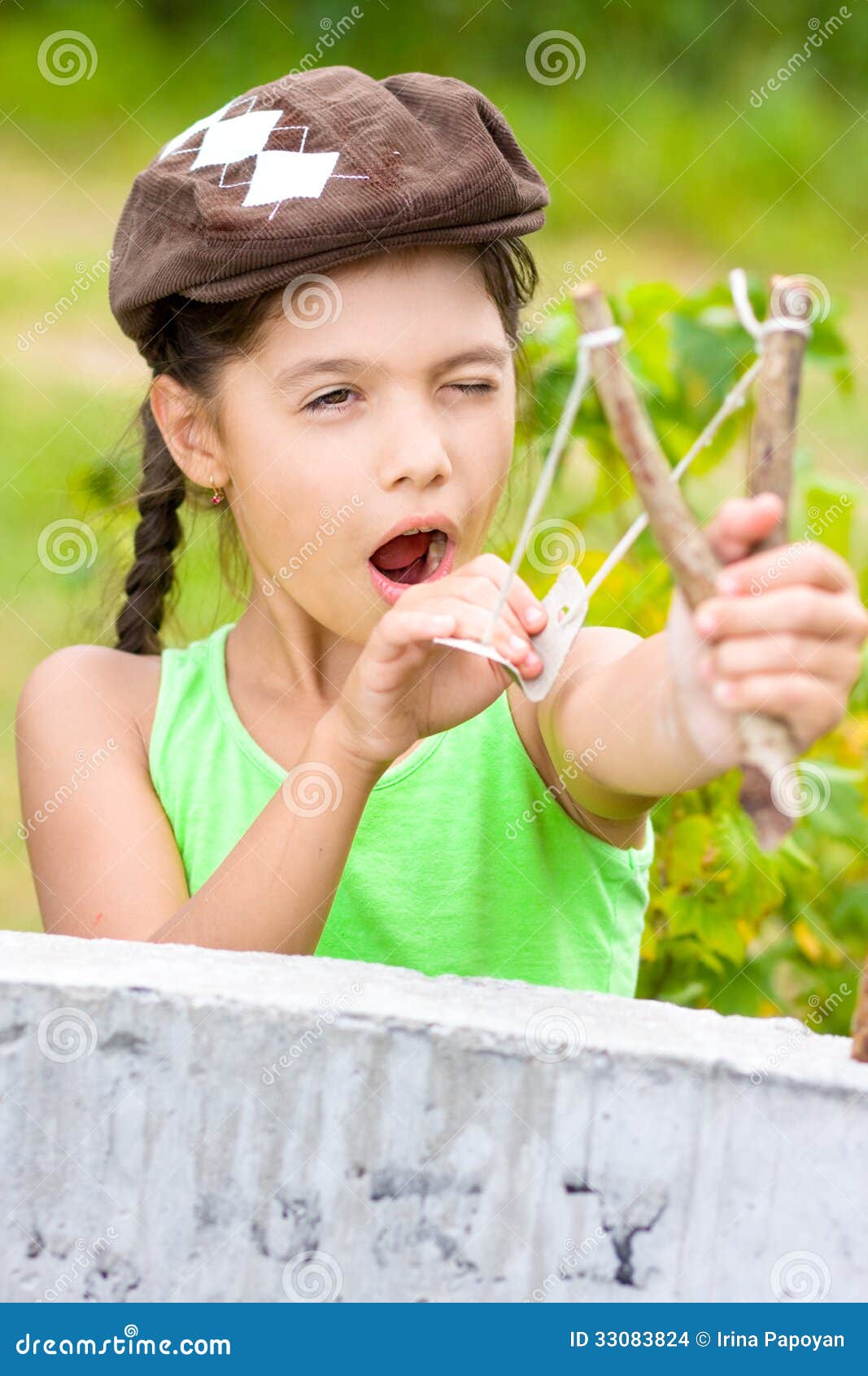 Girl with slingshot stock photo. Image of concentration 33083824