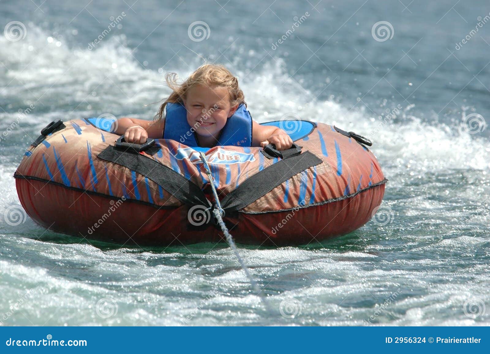 girl smiles aboard water tube