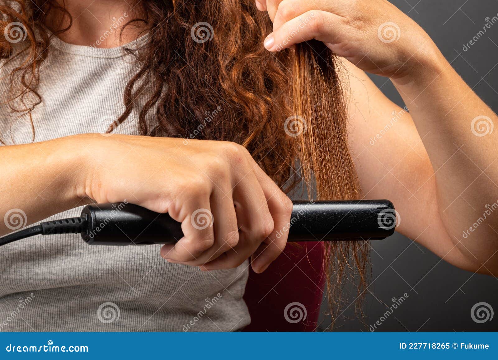Girl Smooths Curly Hair with a Hair Straightener, Curling Iron Stock Image  - Image of girl, care: 227718265