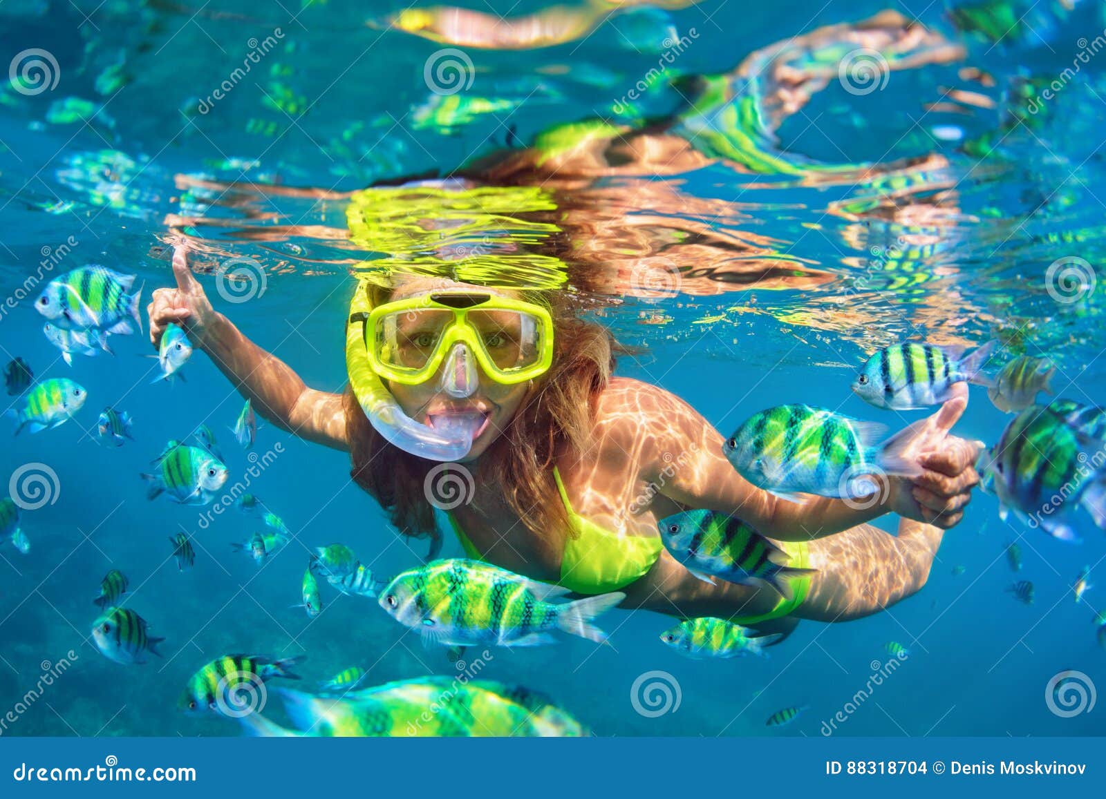 girl in snorkeling mask dive underwater with coral reef fishes