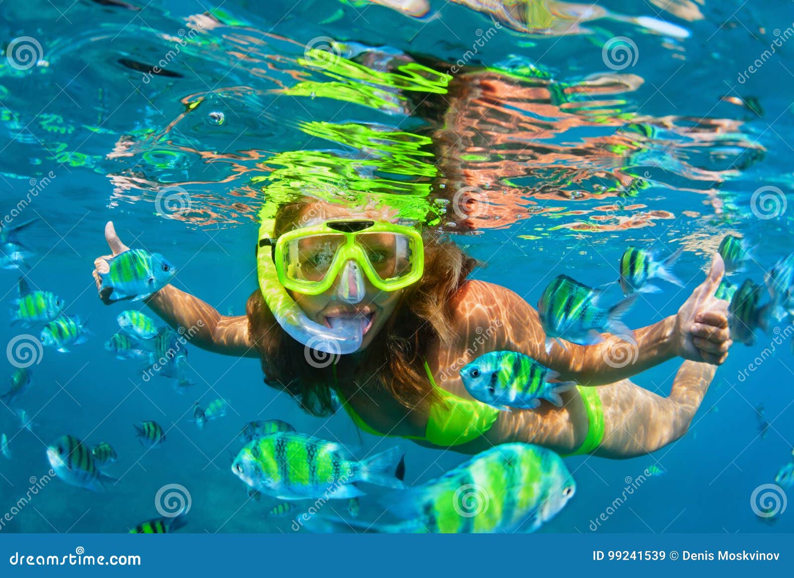 girl in snorkeling mask dive underwater with coral reef fishes