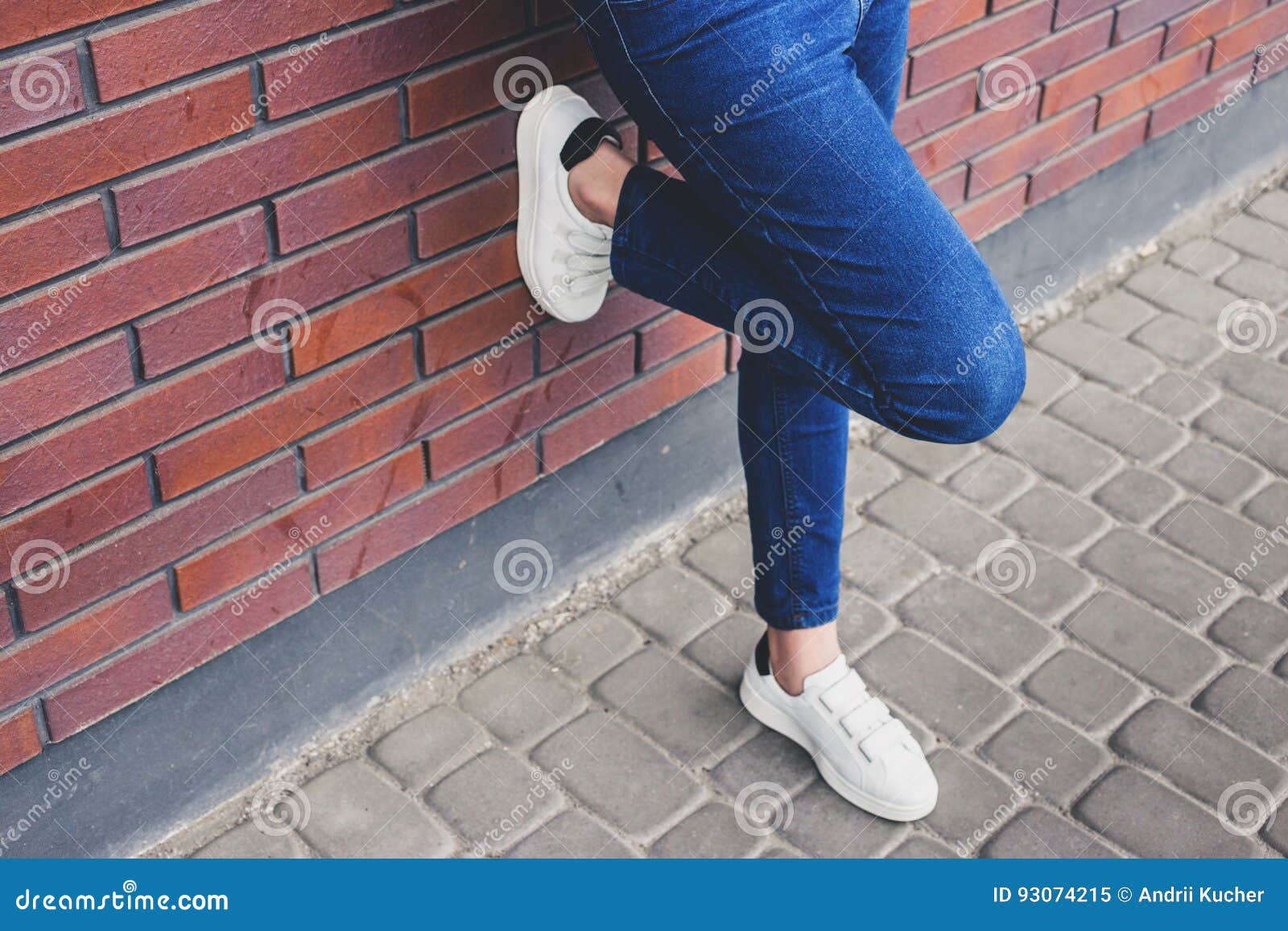 Girl is Standing Near the Wall in Jeans and Sneakers Stock Image ...