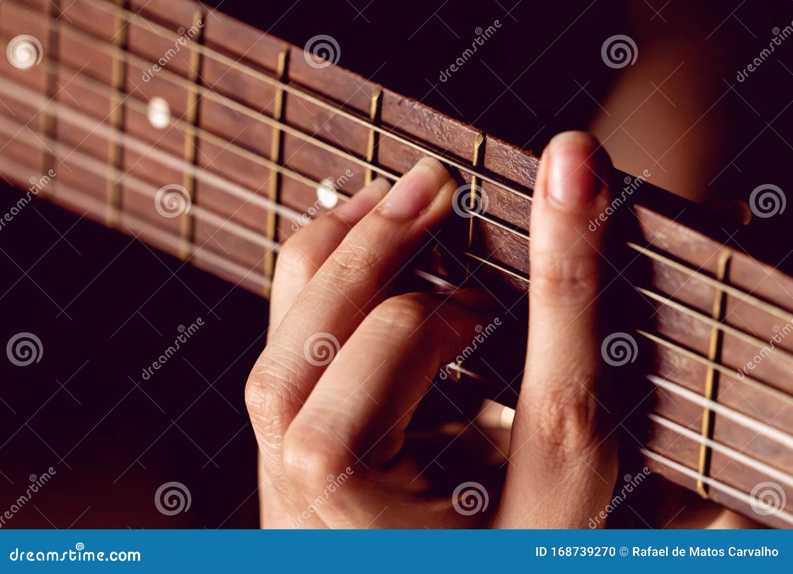 girl strumming the strings of a guitar.