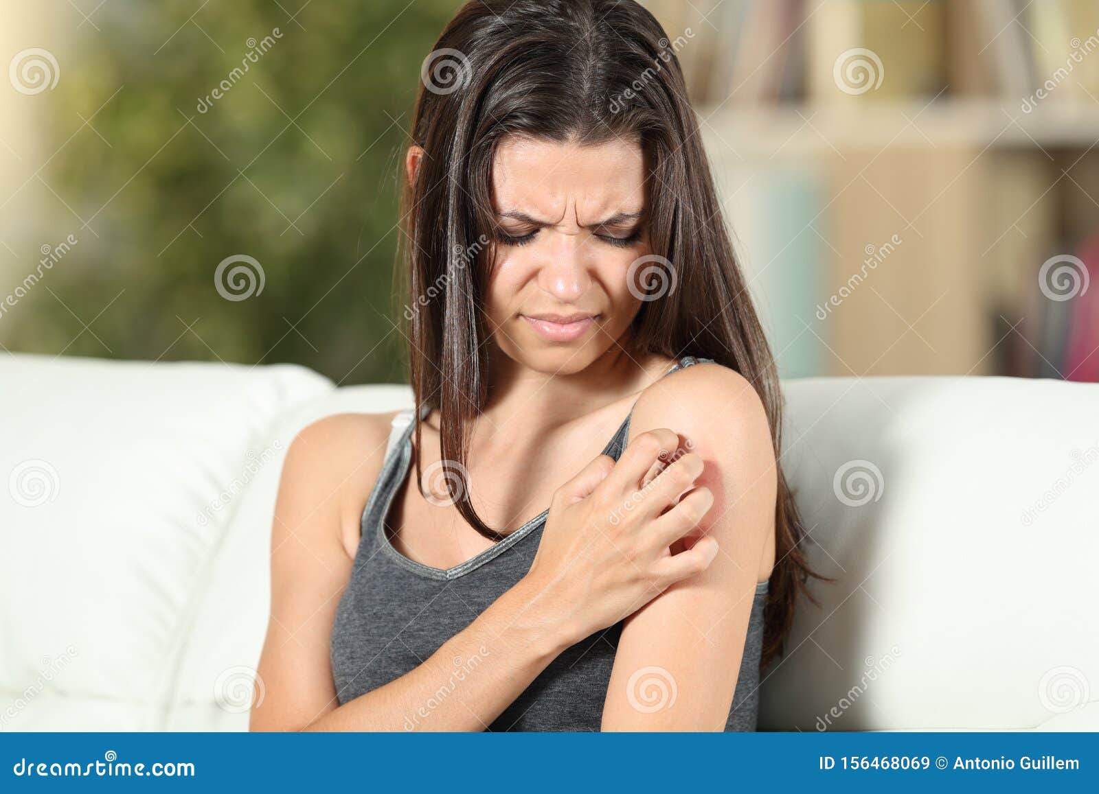 girl suffering skin irritation scratching arm